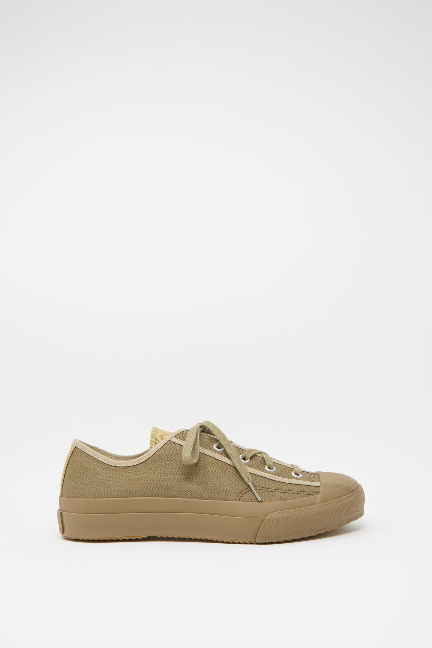 The Gym Classic in Beige Multi by Moonstar is a low-top sneaker crafted from durable canvas. It features laces and a rubber sole, displayed on a plain white background.