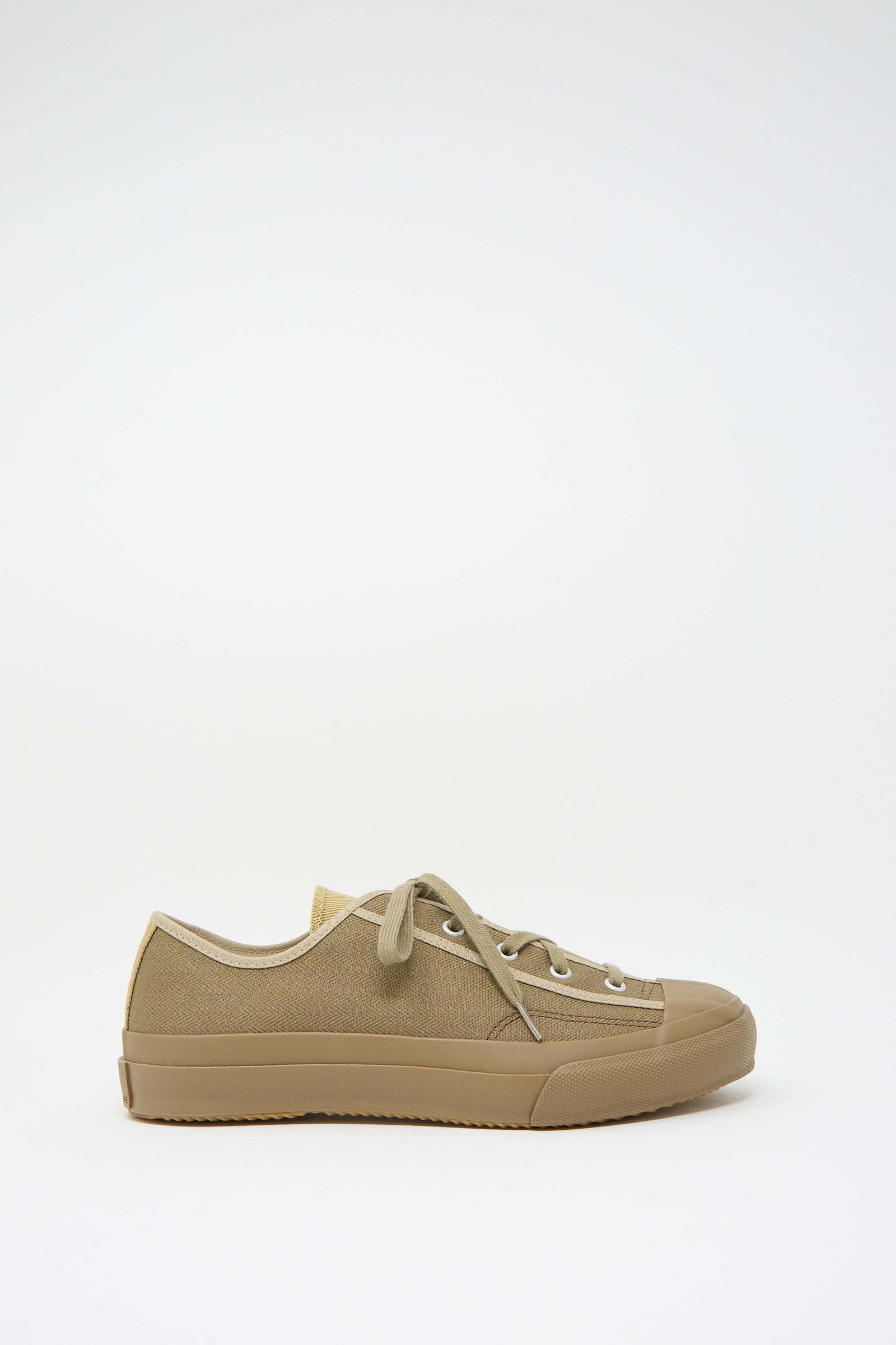 The Gym Classic in Beige Multi by Moonstar is a low-top sneaker crafted from durable canvas. It features laces and a rubber sole, displayed on a plain white background.