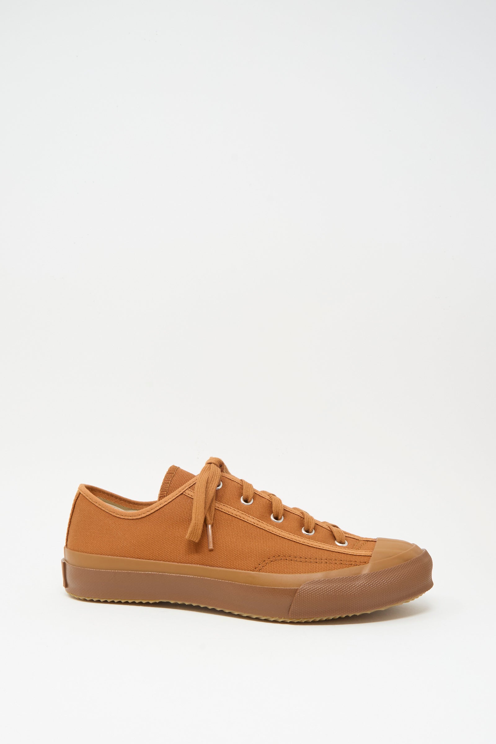 The Gym Classic Sneaker in Brick by Moonstar features a brown canvas low-top design with matching laces and a rubber sole. Made in Japan, it is shown against a plain white background.