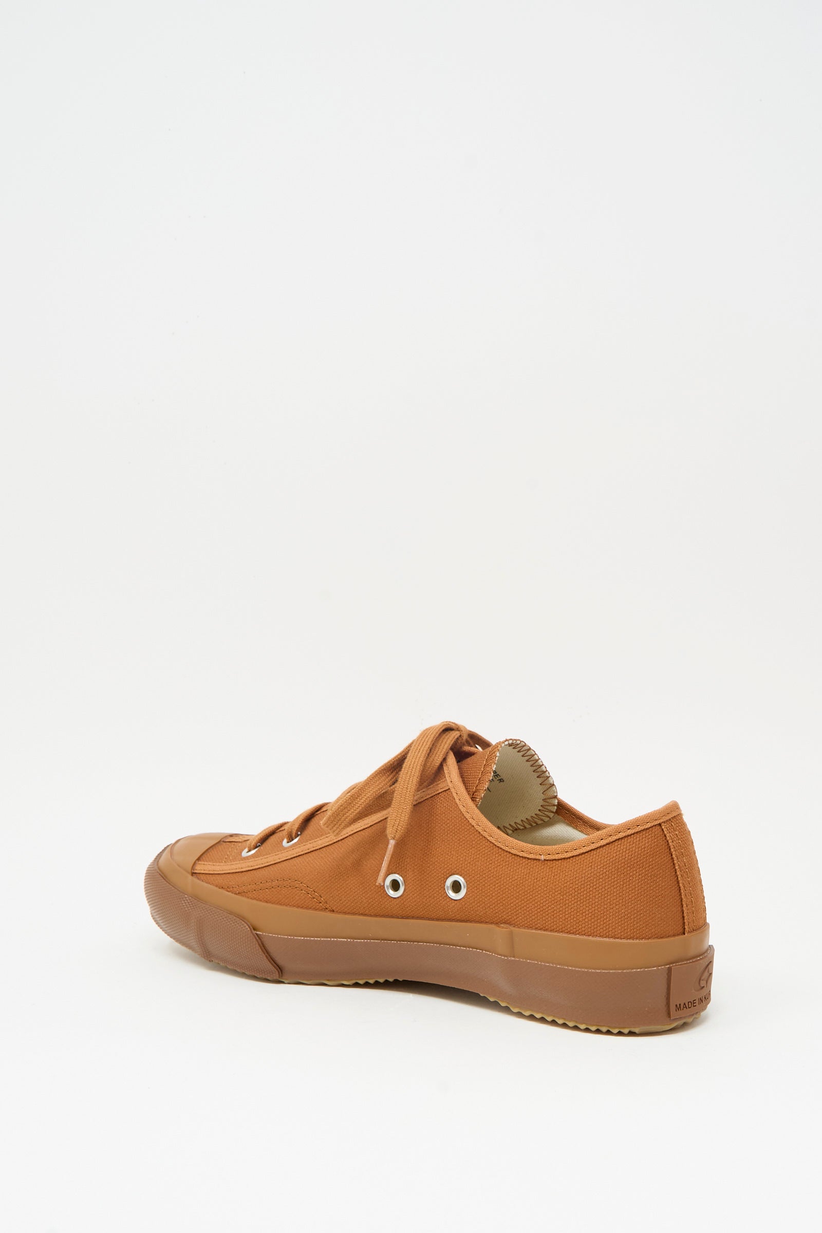 The Moonstar Gym Classic Sneaker in Brick features brown canvas, a rubber sole and toe cap, inspired by classic training shoes, displayed at an angle on a plain white background.