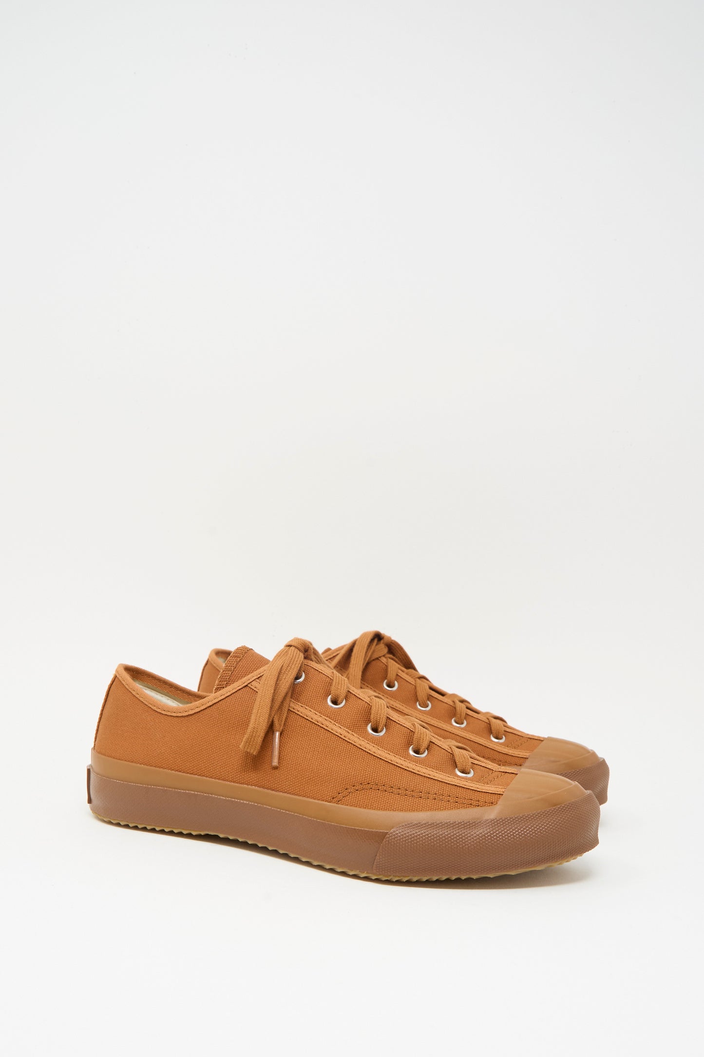 The Moonstar Gym Classic Sneaker in Brick, a brown canvas lace-up shoe with rubber soles made in Japan, is displayed side by side on a plain white background.