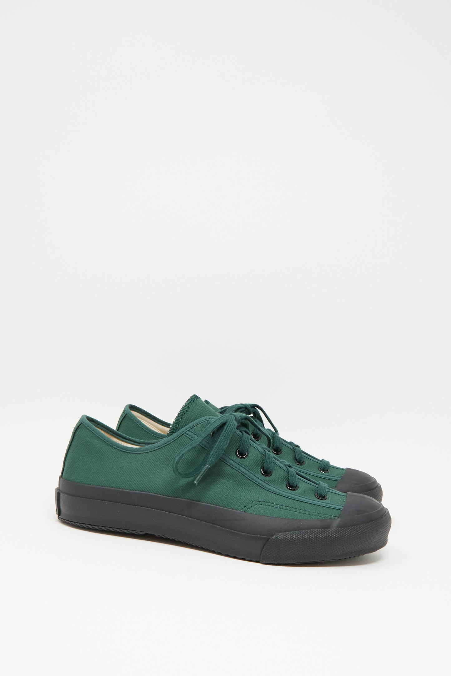 The Moonstar Gym Classic Sneaker in Dark Green is a Japanese-made low-top canvas shoe with black rubber soles and toe caps, shown on a plain white background.
