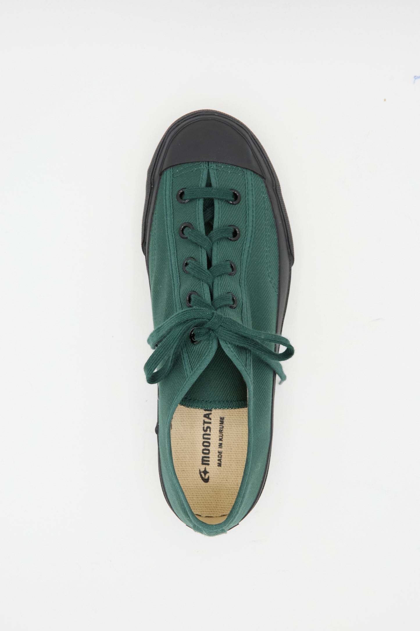 A single Moonstar Gym Classic Sneaker in dark green canvas with a black toe and sole, seen from above, featuring black laces and MONSTER branding on the insole. Made in Japan.