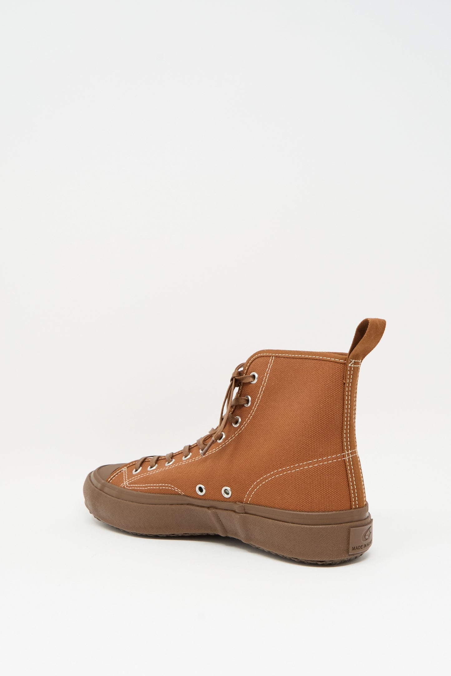 The Moonstar Hi Basket Sneaker in Brown is a vintage-inspired high-top canvas shoe with white stitching, a brown rubber sole, and heel pull tab, shown against a plain white background.