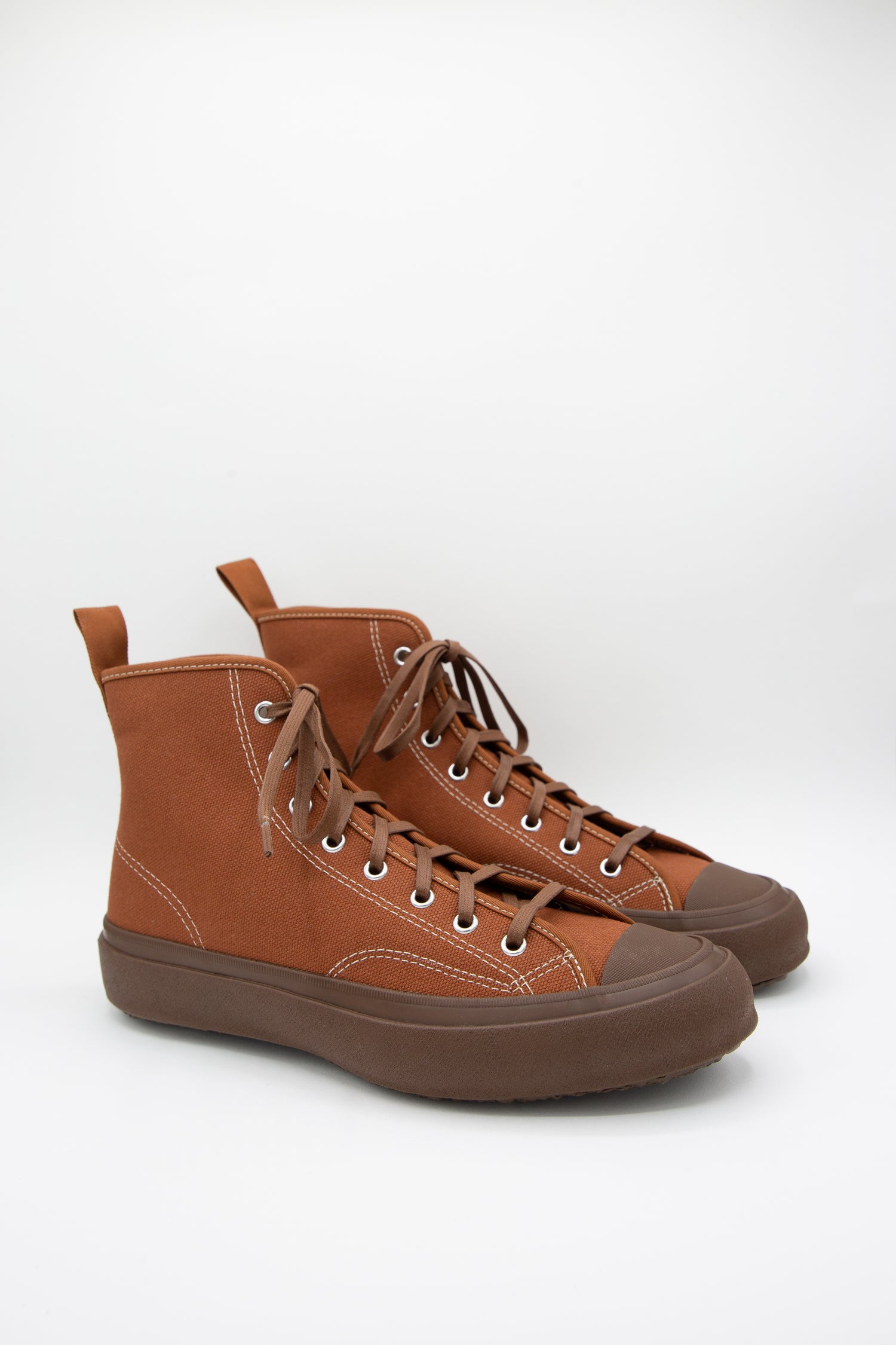 A pair of Moonstar Hibasket sneakers in Brown, with a rubber sole on a white background.