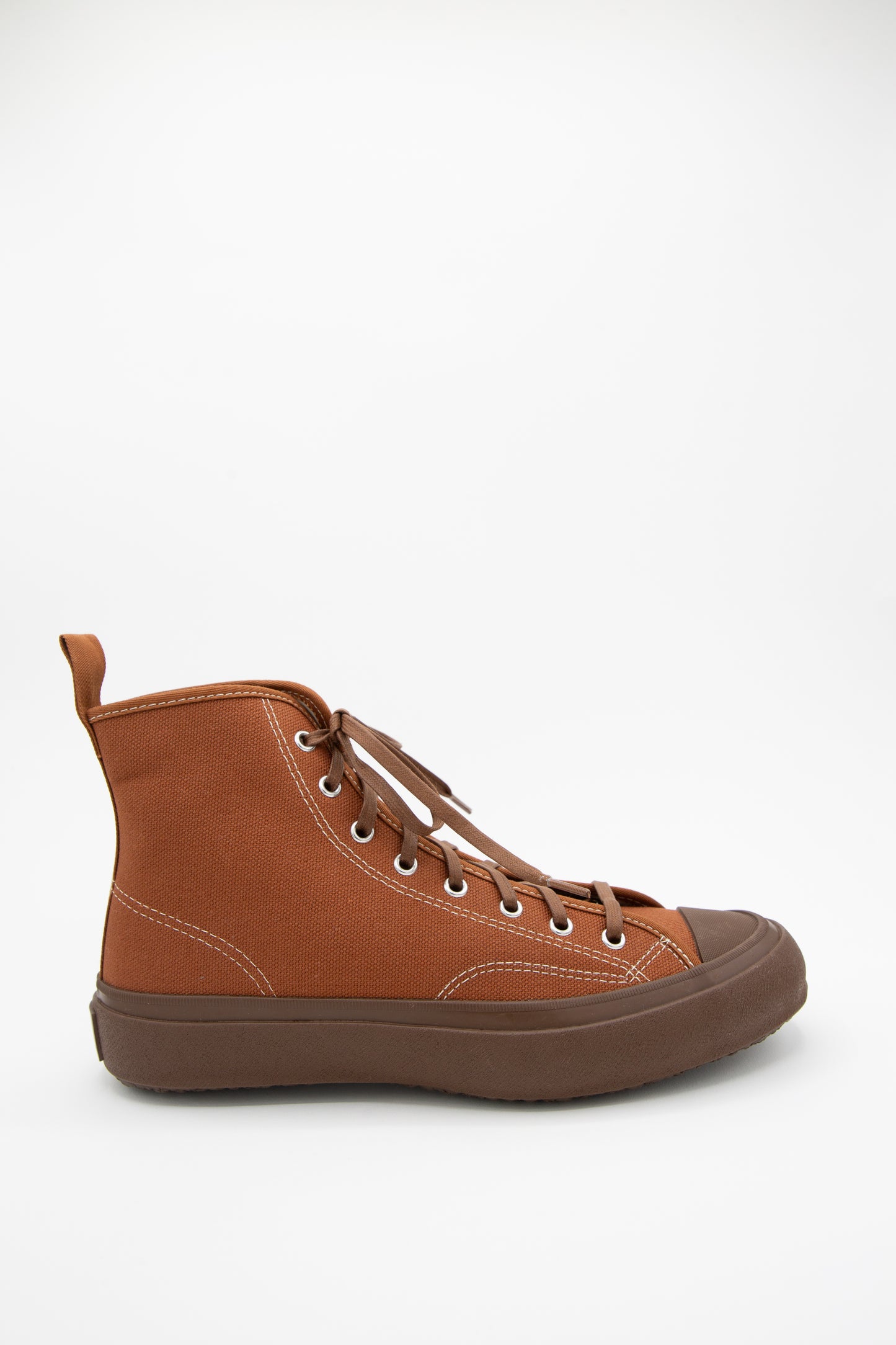The Hibasket Sneaker in Brown by Moonstar features a canvas upper and rubber sole. It is a hi-top sneaker.