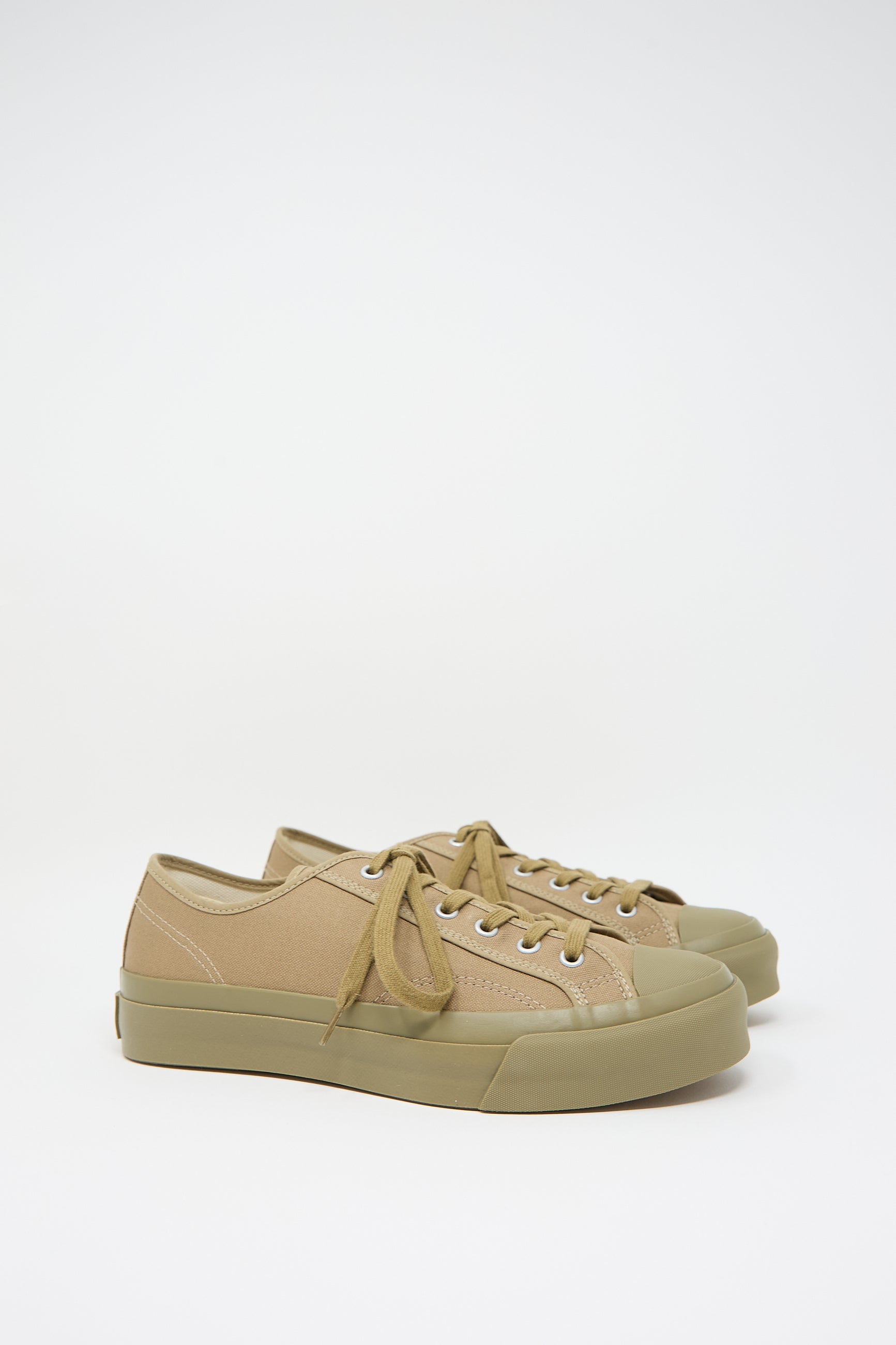 Low Trainer Sneaker in Khaki by Moonstar with brown laces and rubber soles, handmade in Japan, positioned against a white background.