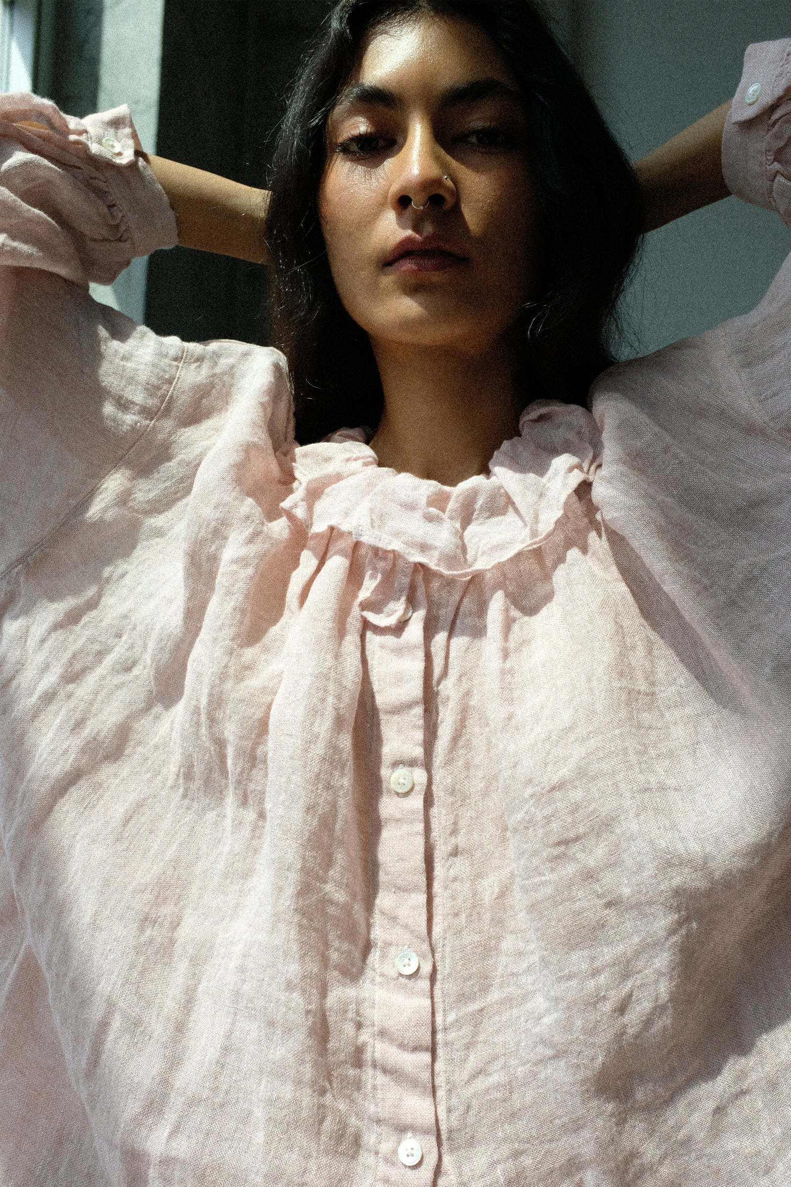 Woman wearing nest Robe's Linen Gauze Frill Blouse, standing against a neutral background.
