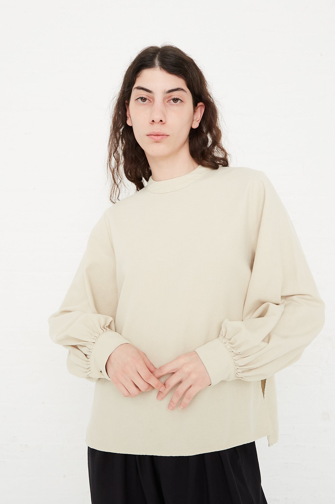 Turtleneck blouse with front slit and cuffed sleeves in beige