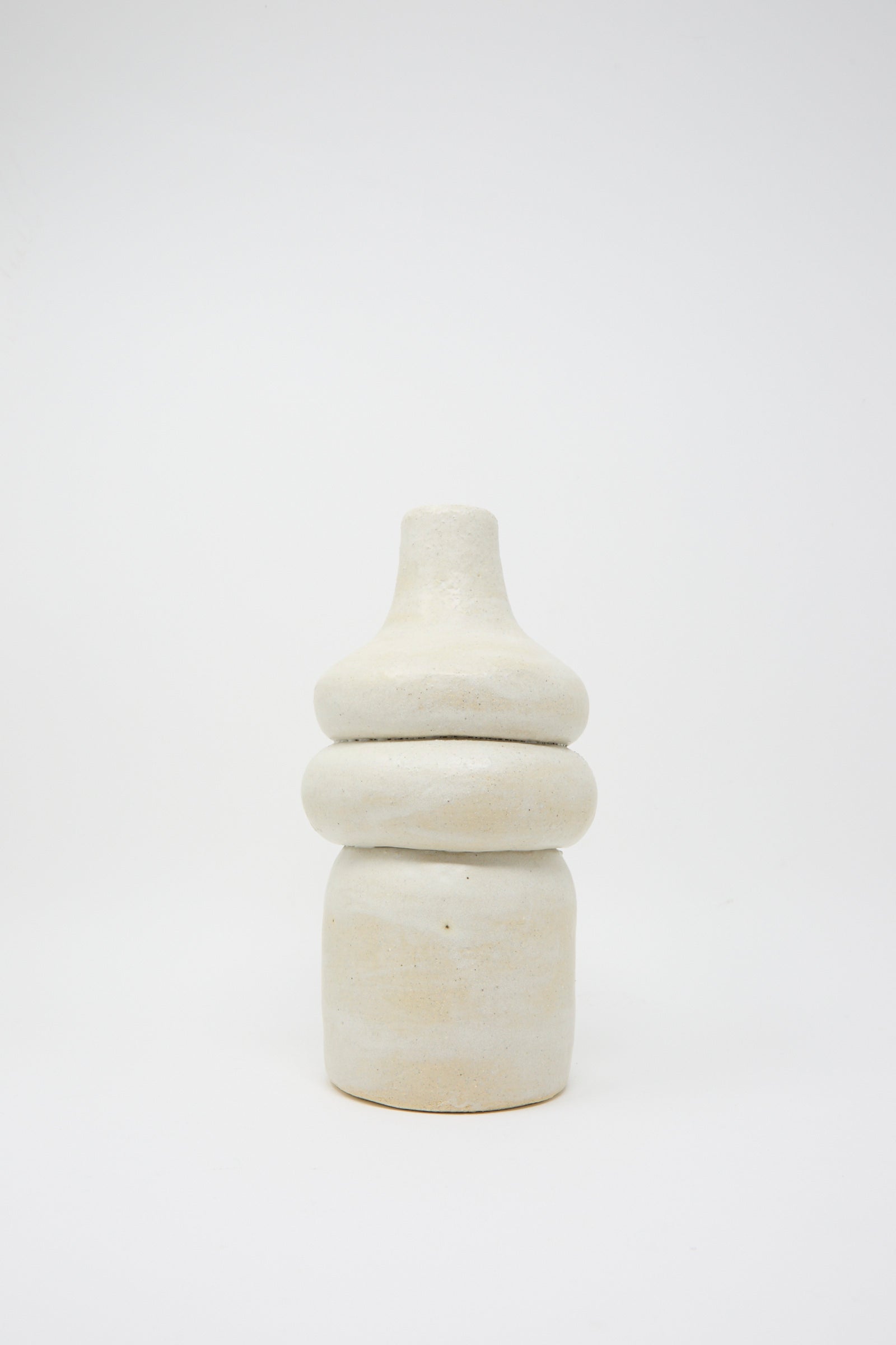 The Prune Vessel by Oatmeal is an abstract ceramic sculpture featuring a white exterior with a rounded base and narrow top, glazed on the interior and set against a plain background.