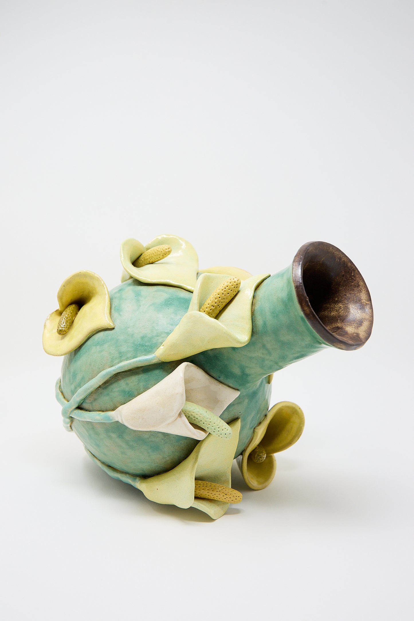 A sculpted ceramic teapot designed to resemble a cluster of Calla lilies, featuring a dark brown rimmed spout by Pearce Williams.
