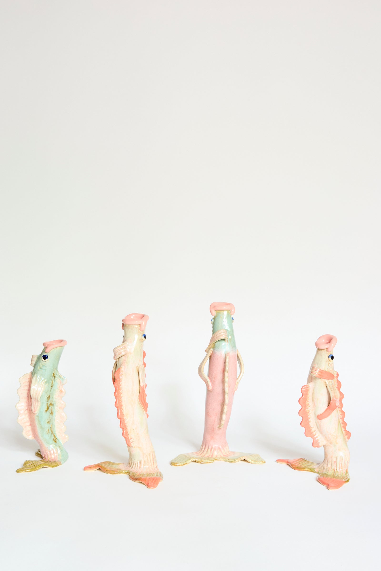 The Pearce Williams Fish Vase Small in Green stands upright against a plain white background, bringing a touch of New Orleans charm.
