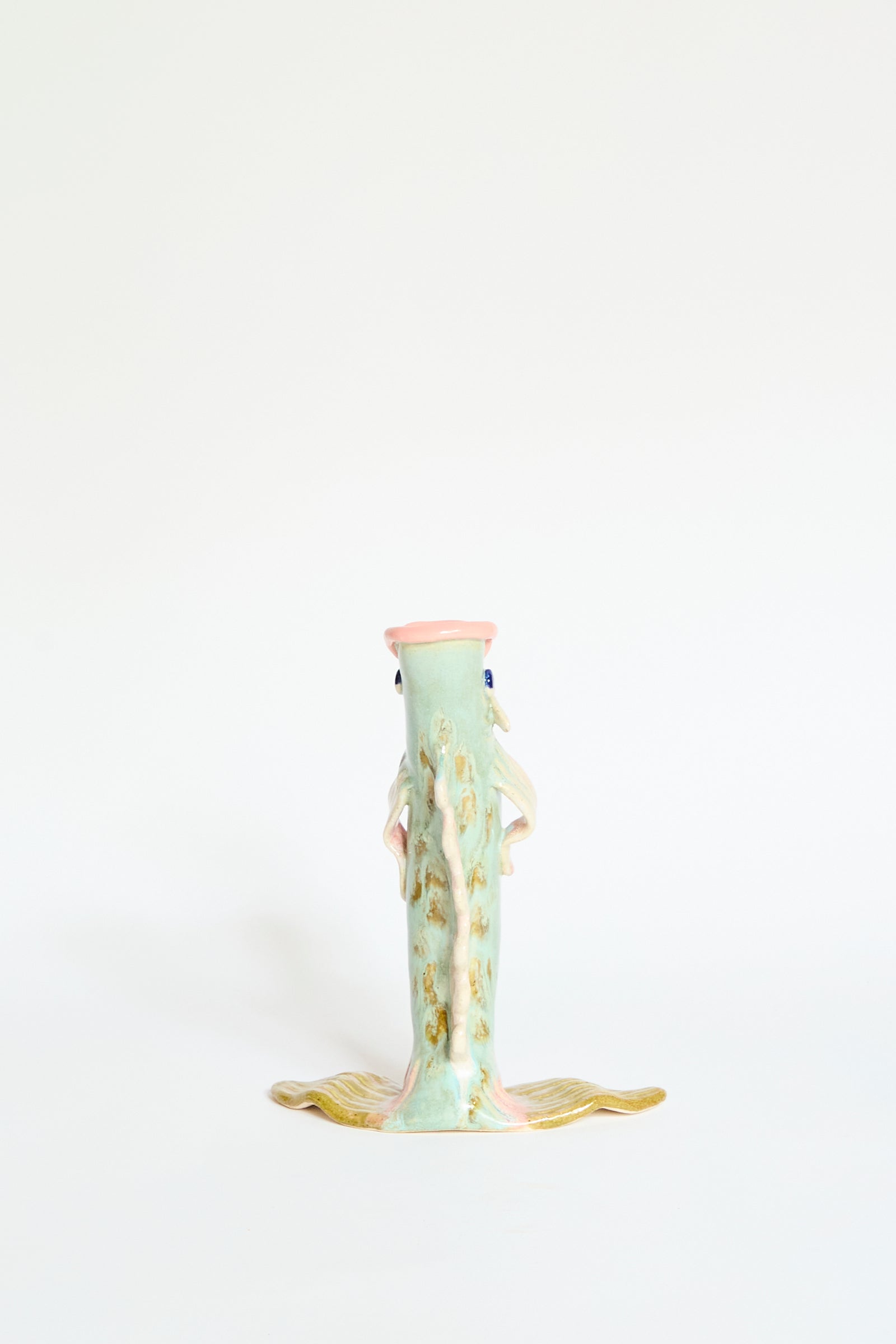 The Fish Vase Small in Green by Pearce Williams is a handmade ceramic sculpture with a vertical fish-shaped design, pastel green tones, and gold-accented fins, showcased against a plain white background.