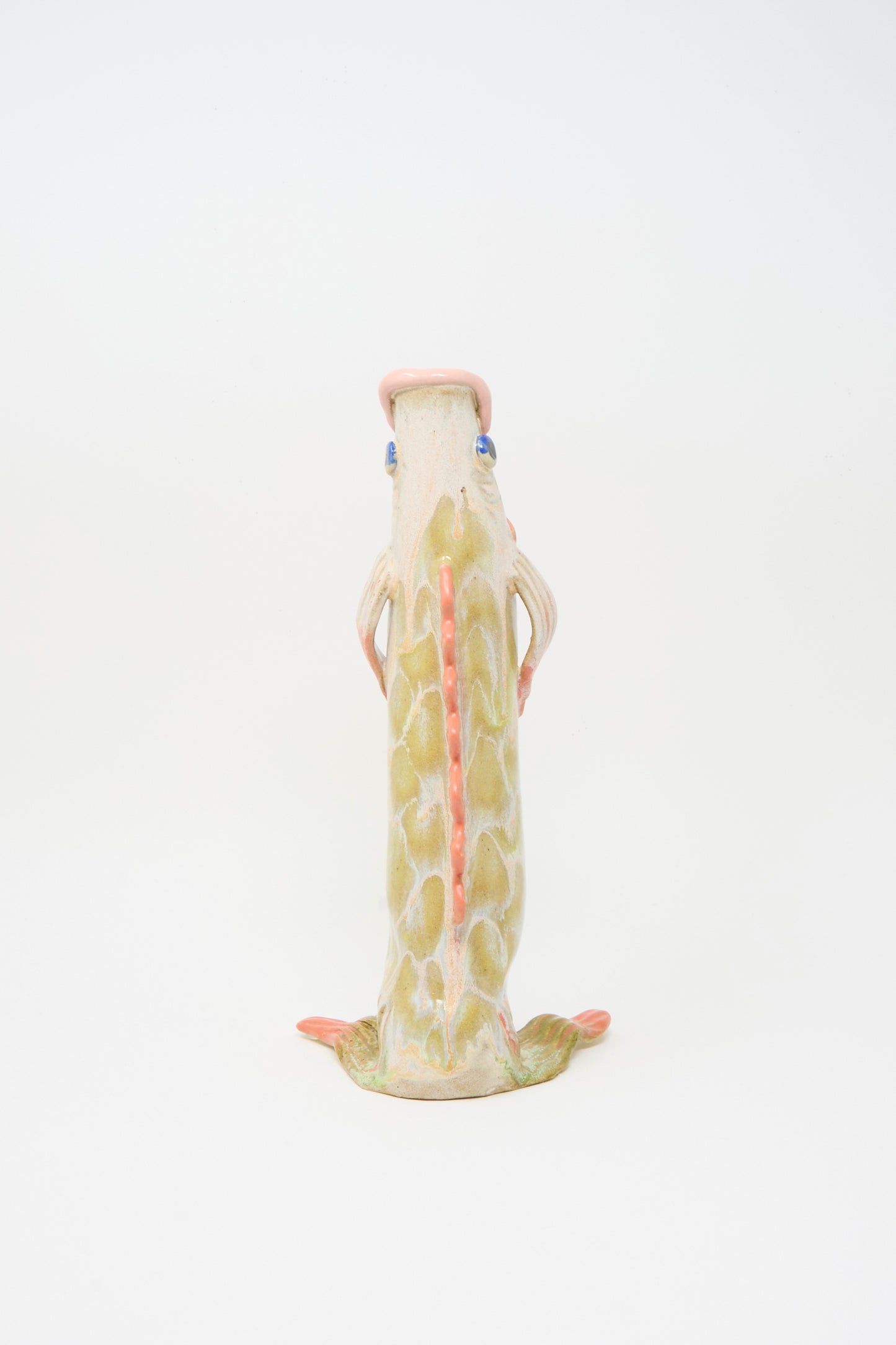 The Fish Vase in Coral III by Pearce Williams is a fish-shaped sculpture with green and pink glazes, textured surface, and bold fins.