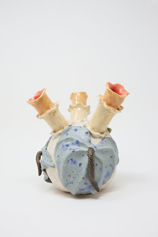 A ceramic sculpture of a Floral Triple Vase, featuring a blue, speckled cactus with three arms, each topped with a pink flower, set against a white background and crafted by Pearce Williams.