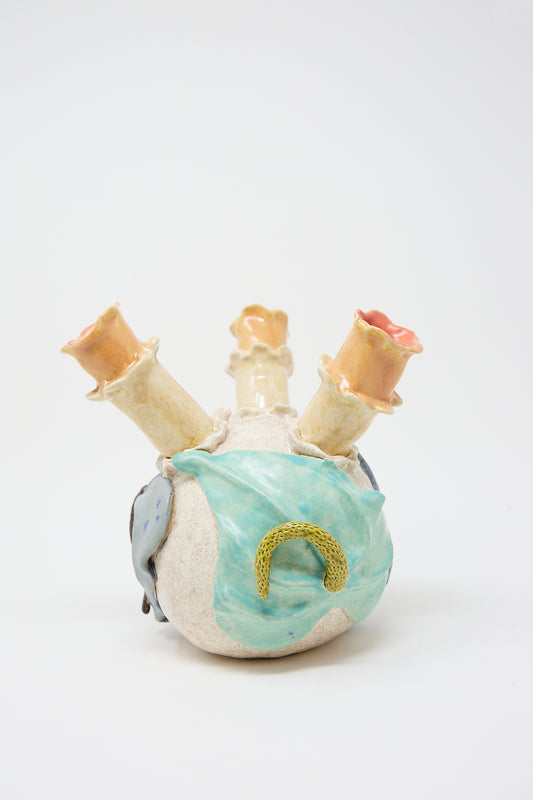 A ceramic sculpture of a Pearce Williams Floral Triple Vase with pastel-colored glazes and abstract, organic forms against a white background.