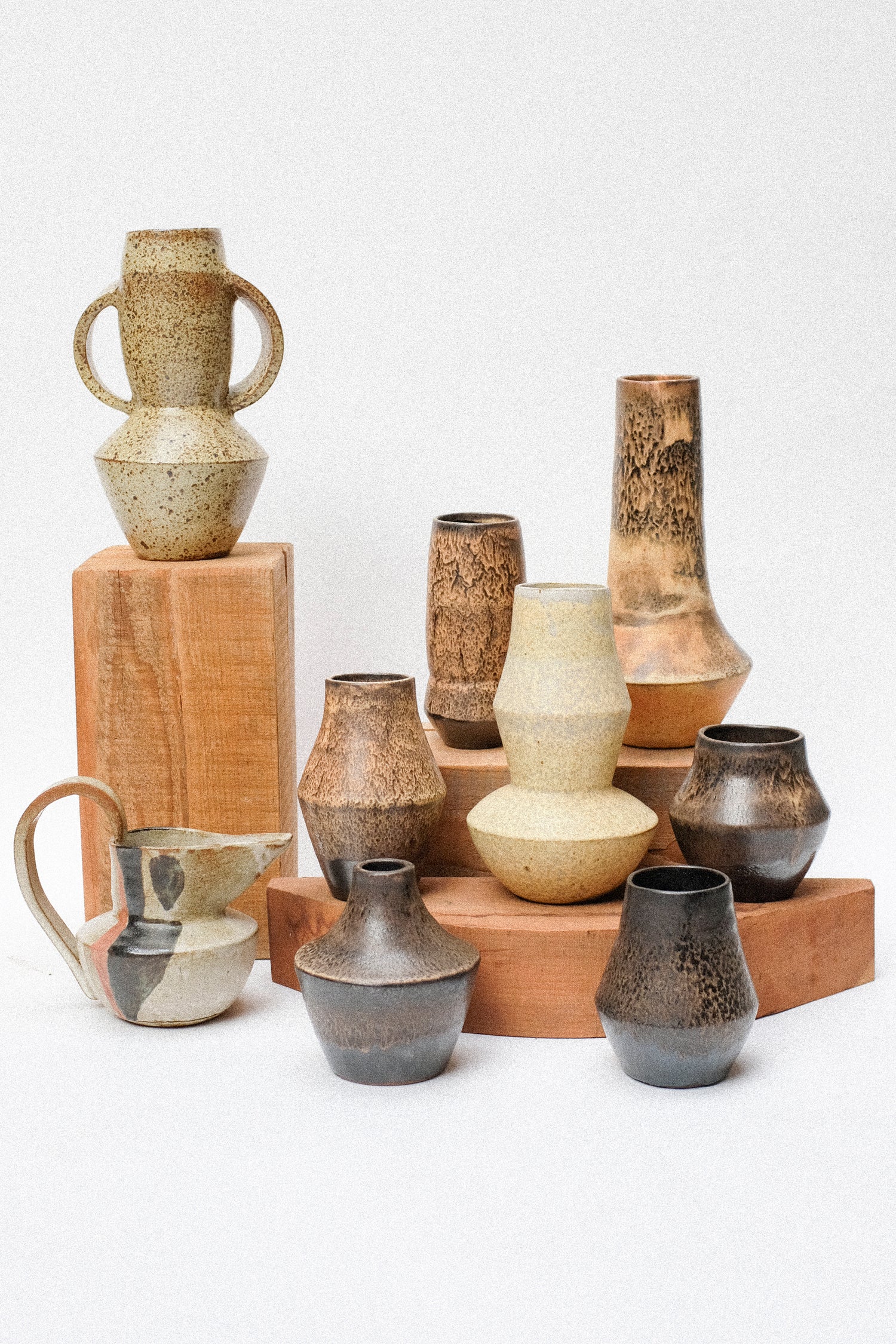 A collection of Rachel Craven ceramics sitting on wood against a white background.