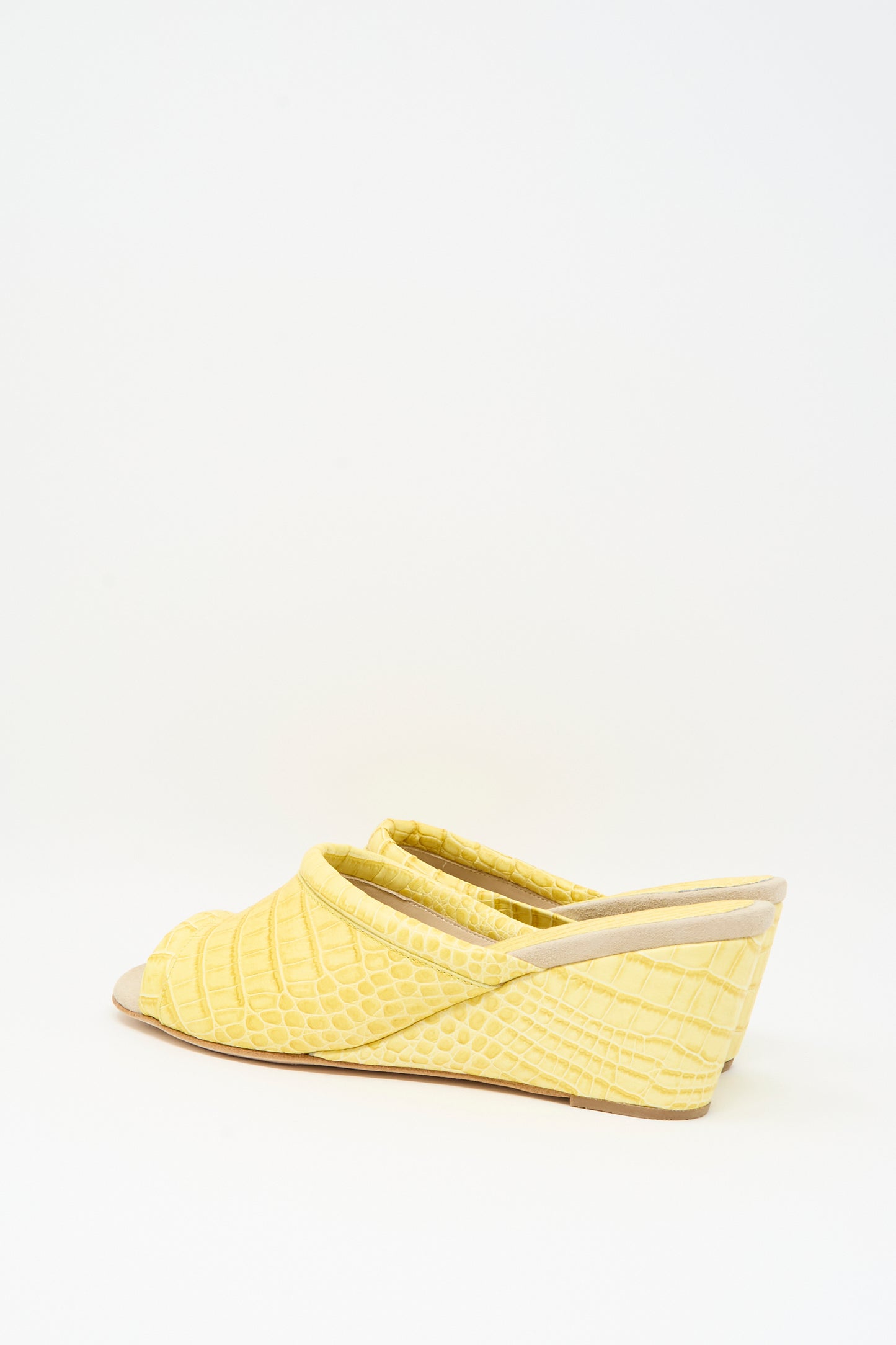 The Bully Mule in Banana by Rachel Comey is a yellow leather mule with an open-toe design and chic wedge heel, showcasing a textured snakeskin pattern reminiscent of crocodile skin, set against a plain white background.