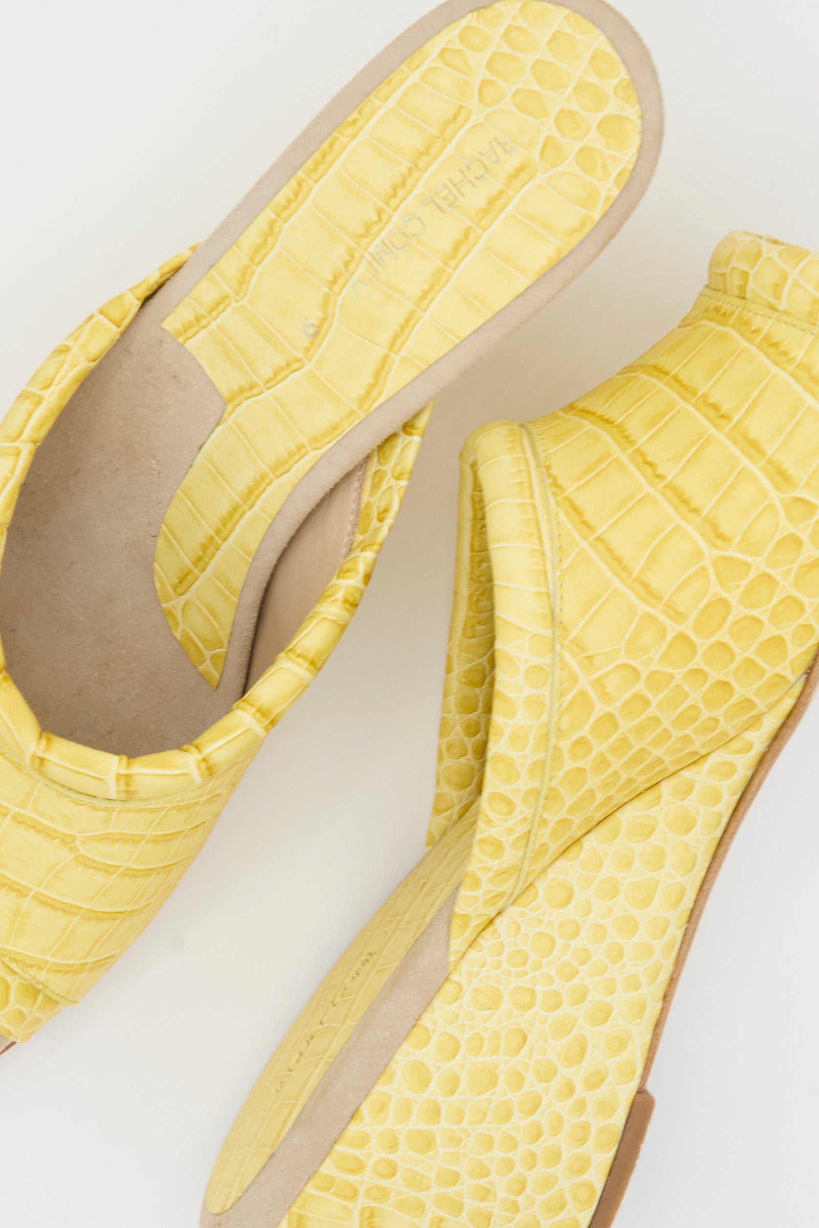 Two Bully Mule in Banana shoes by Rachel Comey, featuring yellow leather with a crocodile embossed texture, are displayed on a white background—one facing up and the other facing down.