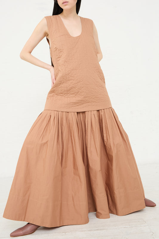 Woman posing in a sleeveless Calin Dress in Camel by Rachel Comey with hand on hip.