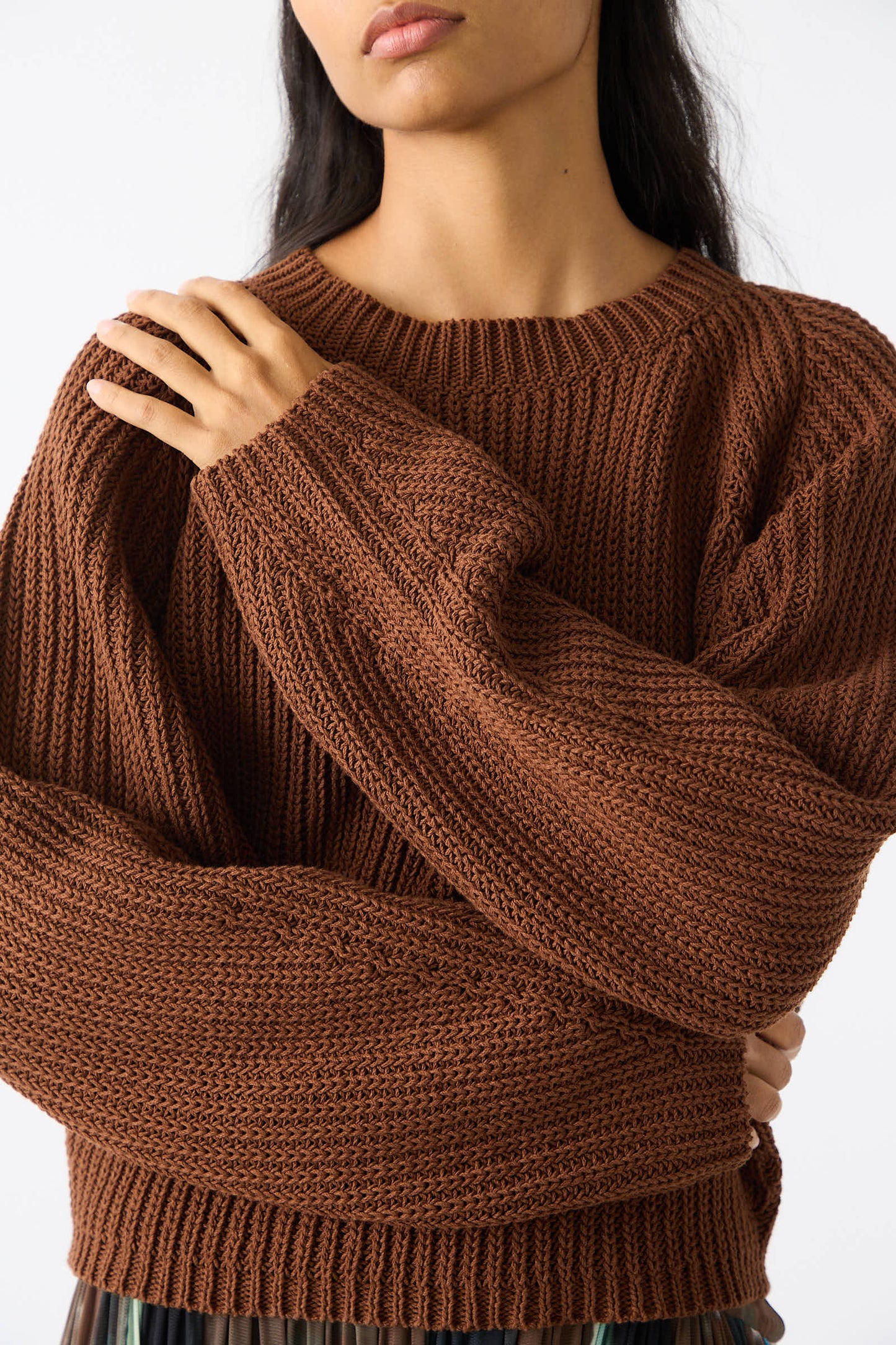 Person wearing a Rachel Comey Cotton Salla Sweater in Brown with balloon sleeves, arms crossed over their chest.