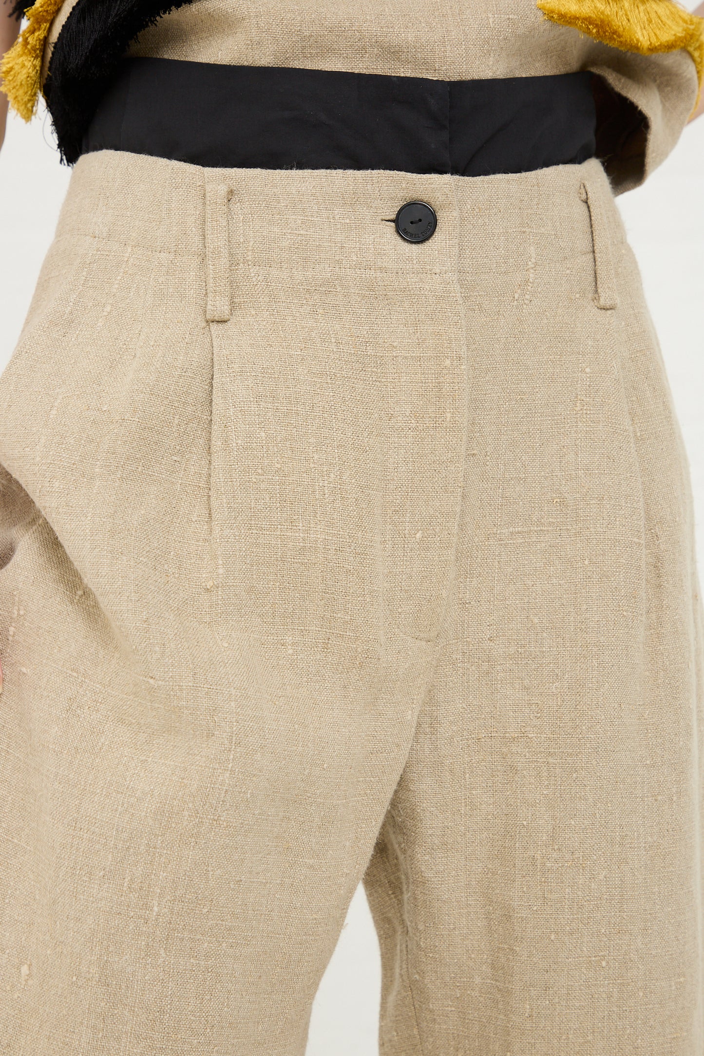 Close-up of beige textured Ditto Pant in Natural with a button closure from the Rachel Comey and Joan Jonas collaboration.