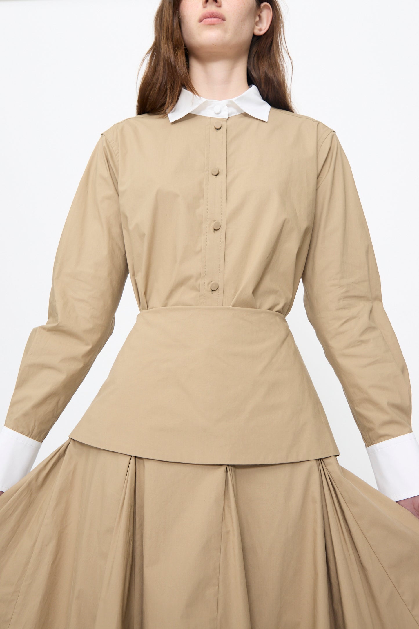 A person wearing the Rachel Comey Heni Skirt in khaki, standing against a plain background.