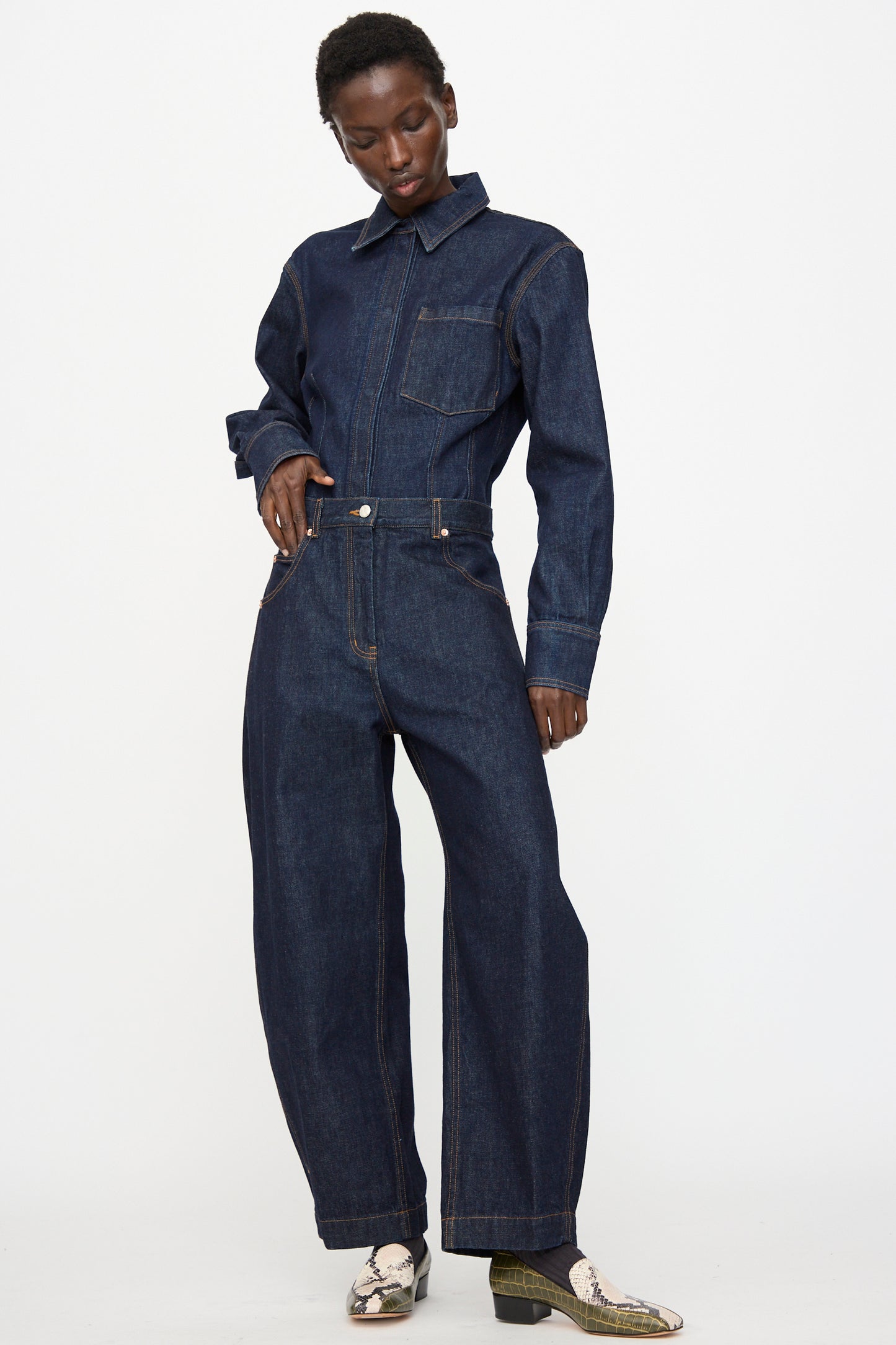 A person wears the Rachel Comey Keenan Pant in Raw Wash with patterned shoes, standing against a plain white background.