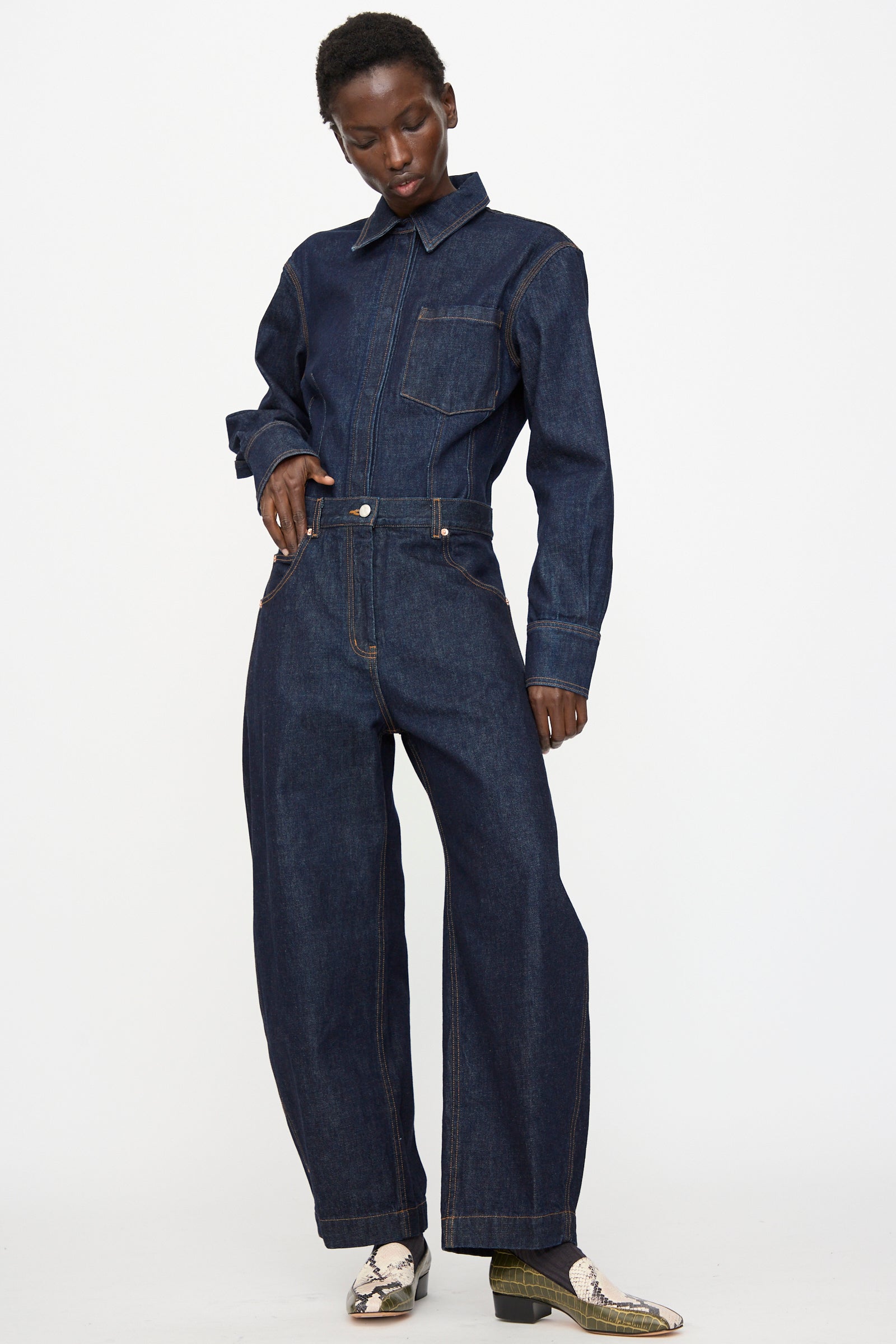 A person wears the Rachel Comey Keenan Pant in Raw Wash with patterned shoes, standing against a plain white background.