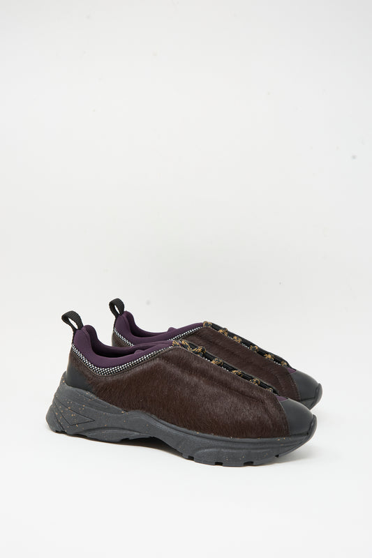The Rachel Comey Pilla Sneaker in Chestnut, featuring black soles and faux fur uppers, made in Portugal, is shown against a plain white background.