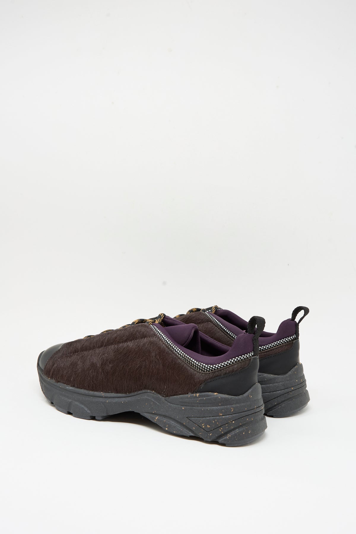A pair of Rachel Comey Pilla Sneakers in Chestnut, featuring textured sides, black soles, and a purple inner lining, made in Portugal, is displayed on a plain white background.