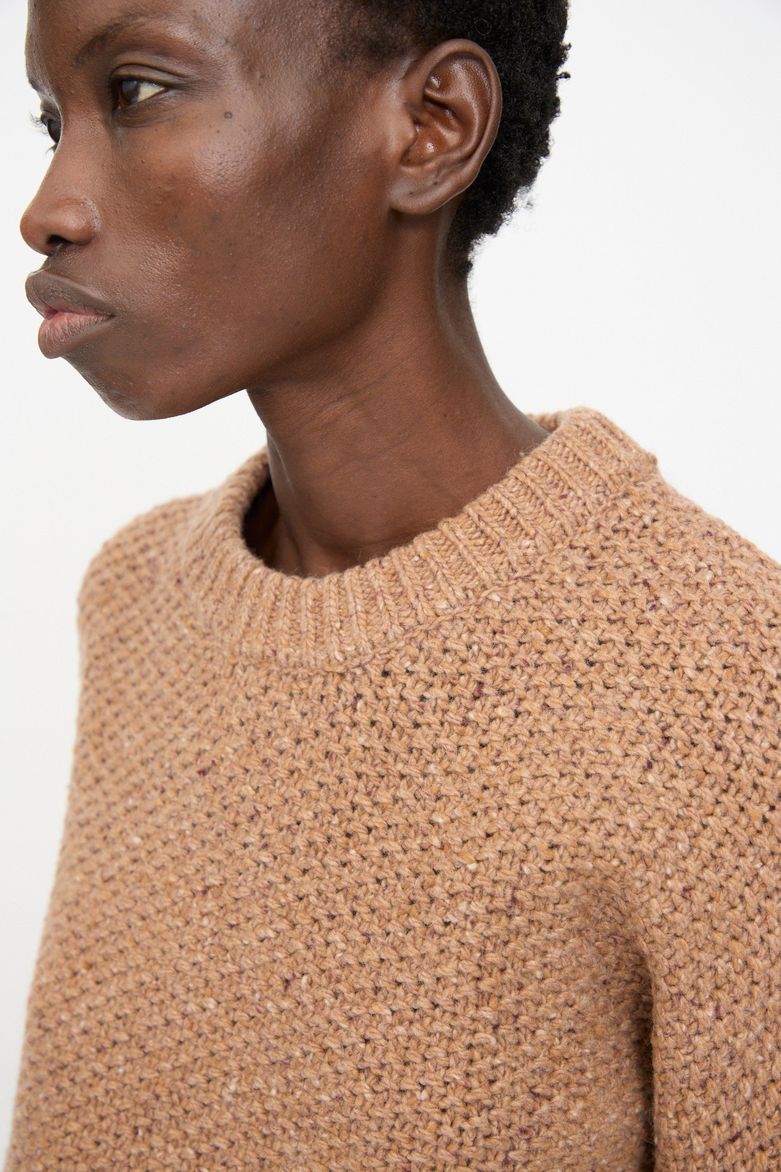 A person models the Rachel Comey Prescot Sweater in Caramel—a heavyweight, textured knit—shown from the side against a plain white background.