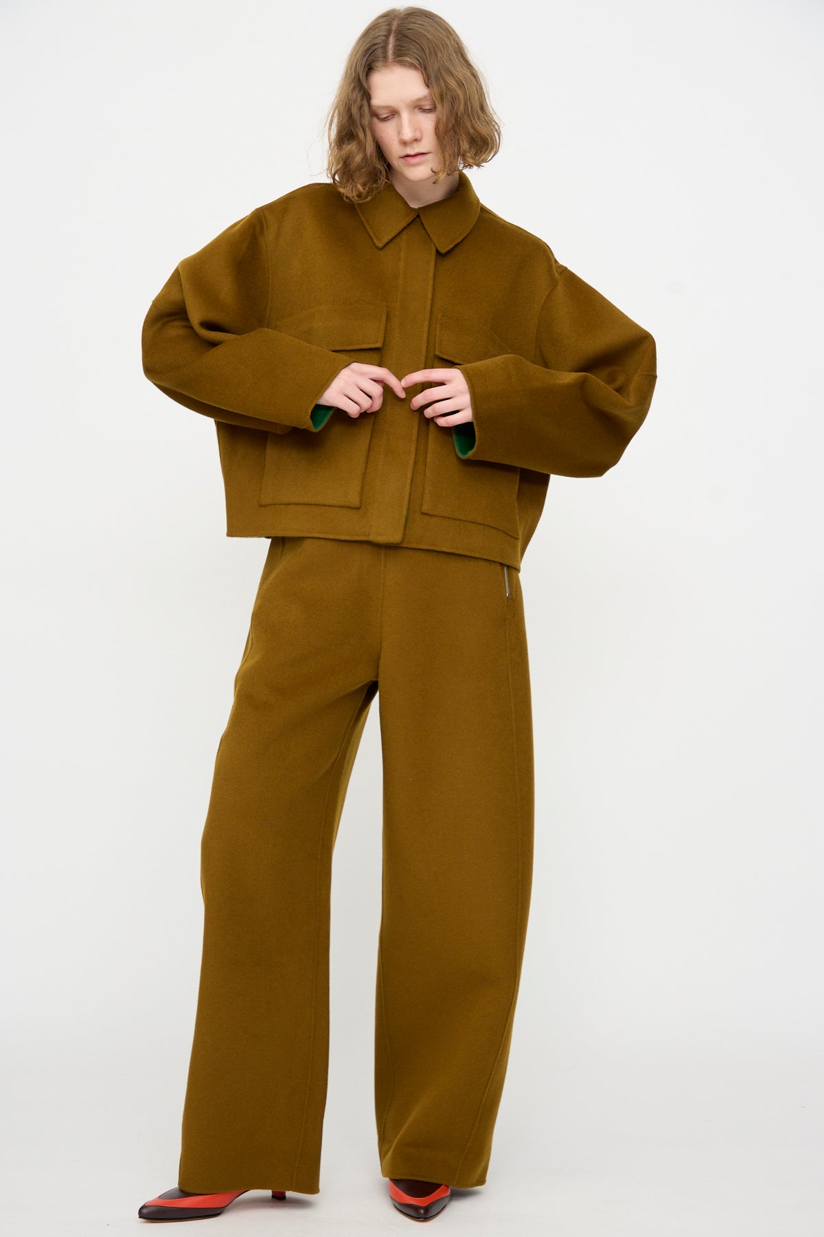 A person is wearing the Rachel Comey Site Jacket in Bronze, styled with matching wide-leg pants, standing against a plain white background.