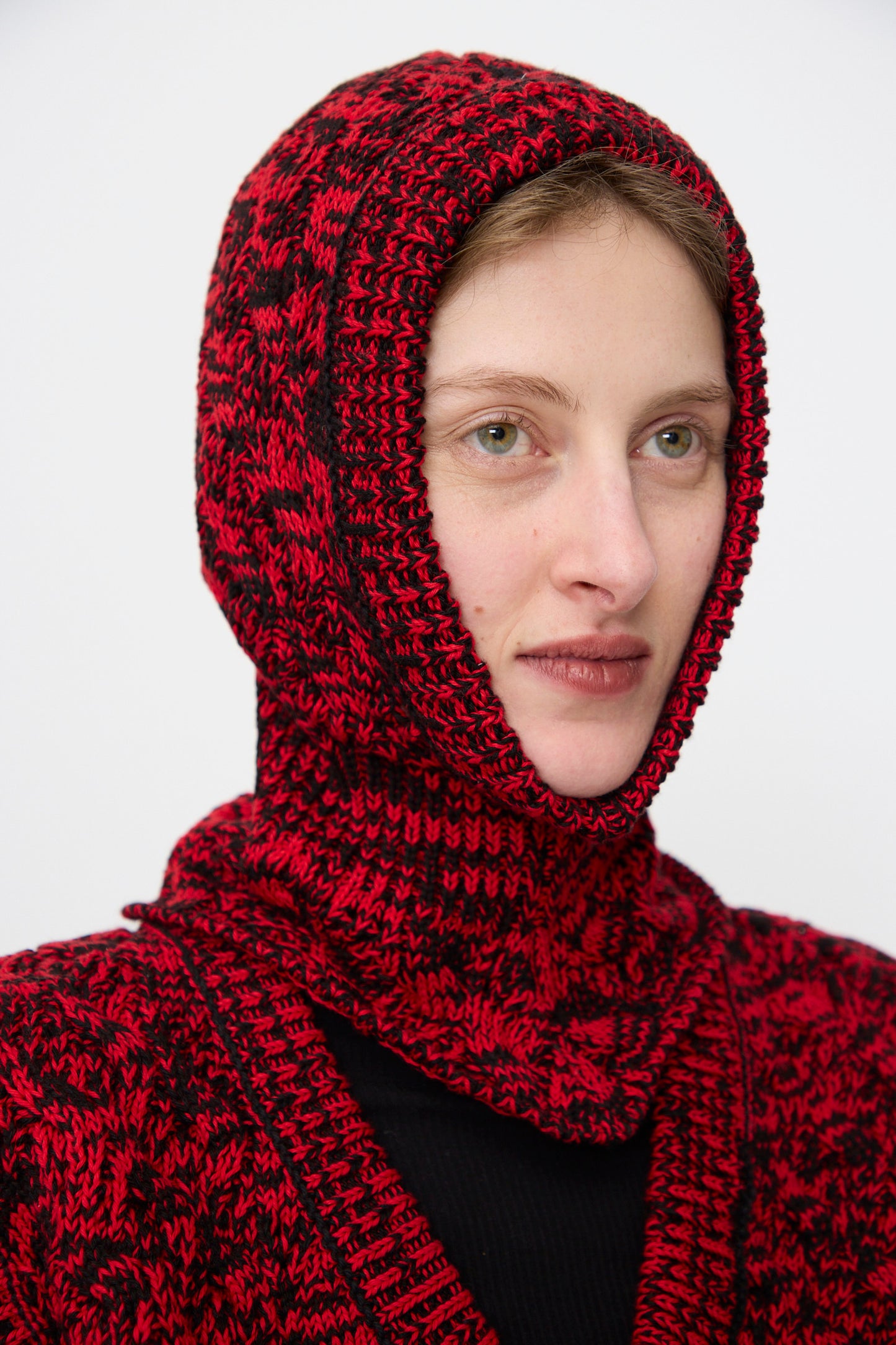 A person wears the Rachel Comey Zet Balaclava in Red Marle with a matching top, facing slightly left against a plain white background.