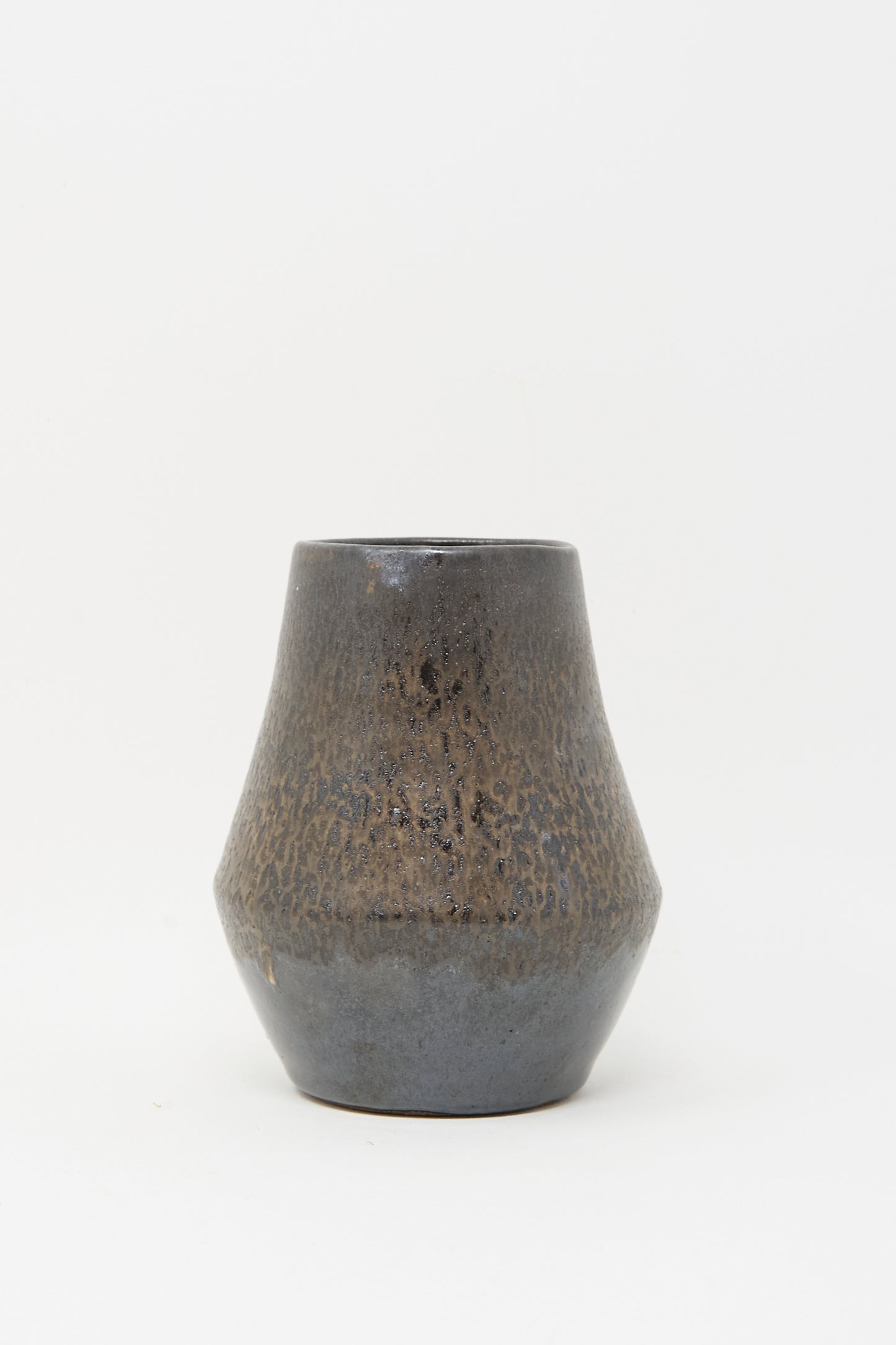 The Small Sap Vase in Black III by Rachel Craven features a dark, mineral glaze with a wide base, slightly tapered neck, and mottled brown and black texture, shown against a plain white background.