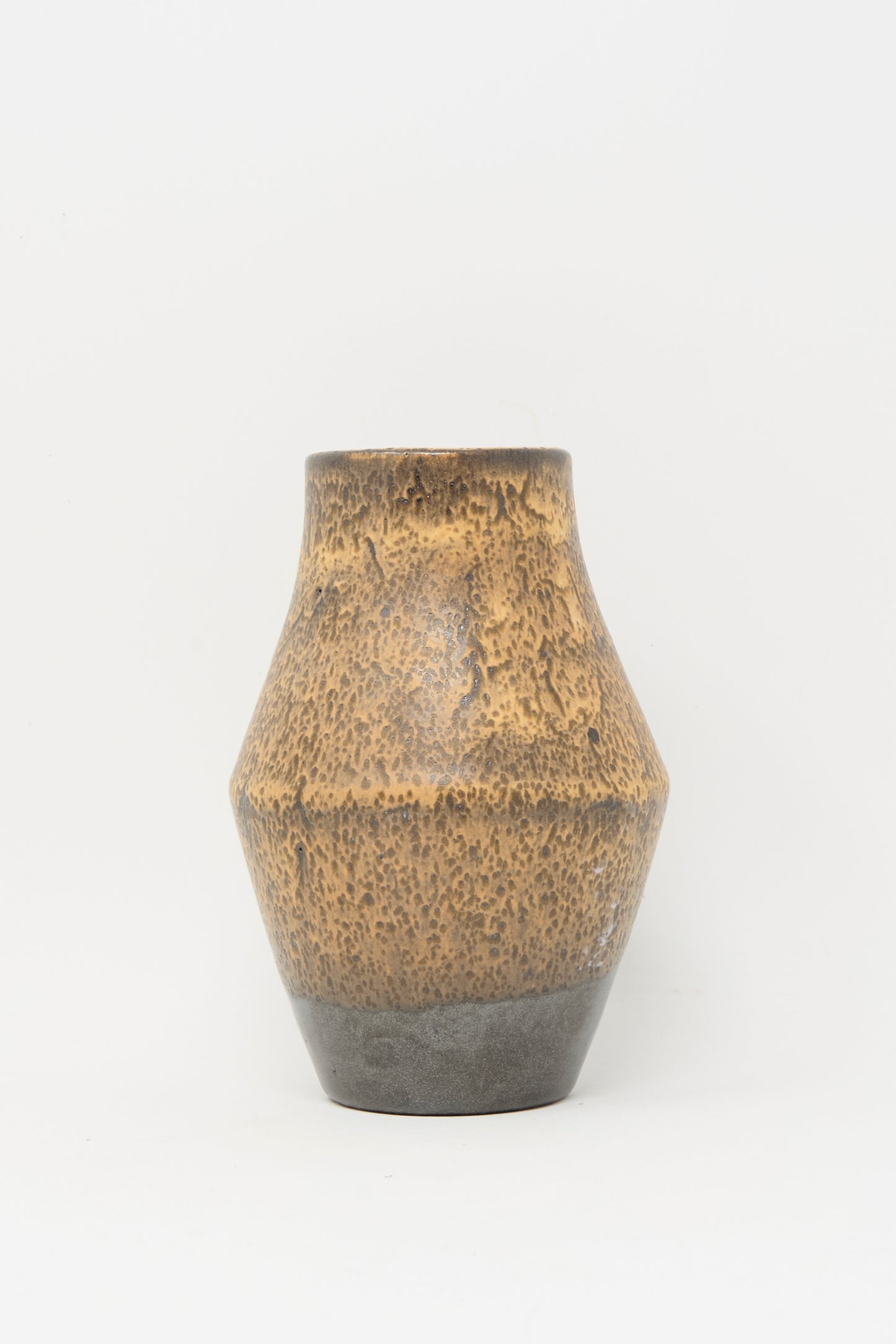 The Small Sap Vase in Brown by Rachel Craven features a wide body, narrow neck, and dark gray base that highlights its wheel-thrown texture, set against a plain white background.