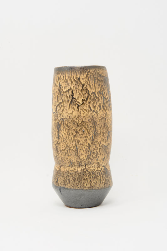 The Tall Sap Vase in Brown by Rachel Craven features a handmade, textured brown and tan surface with a slightly flared base, displayed against a plain white background.
