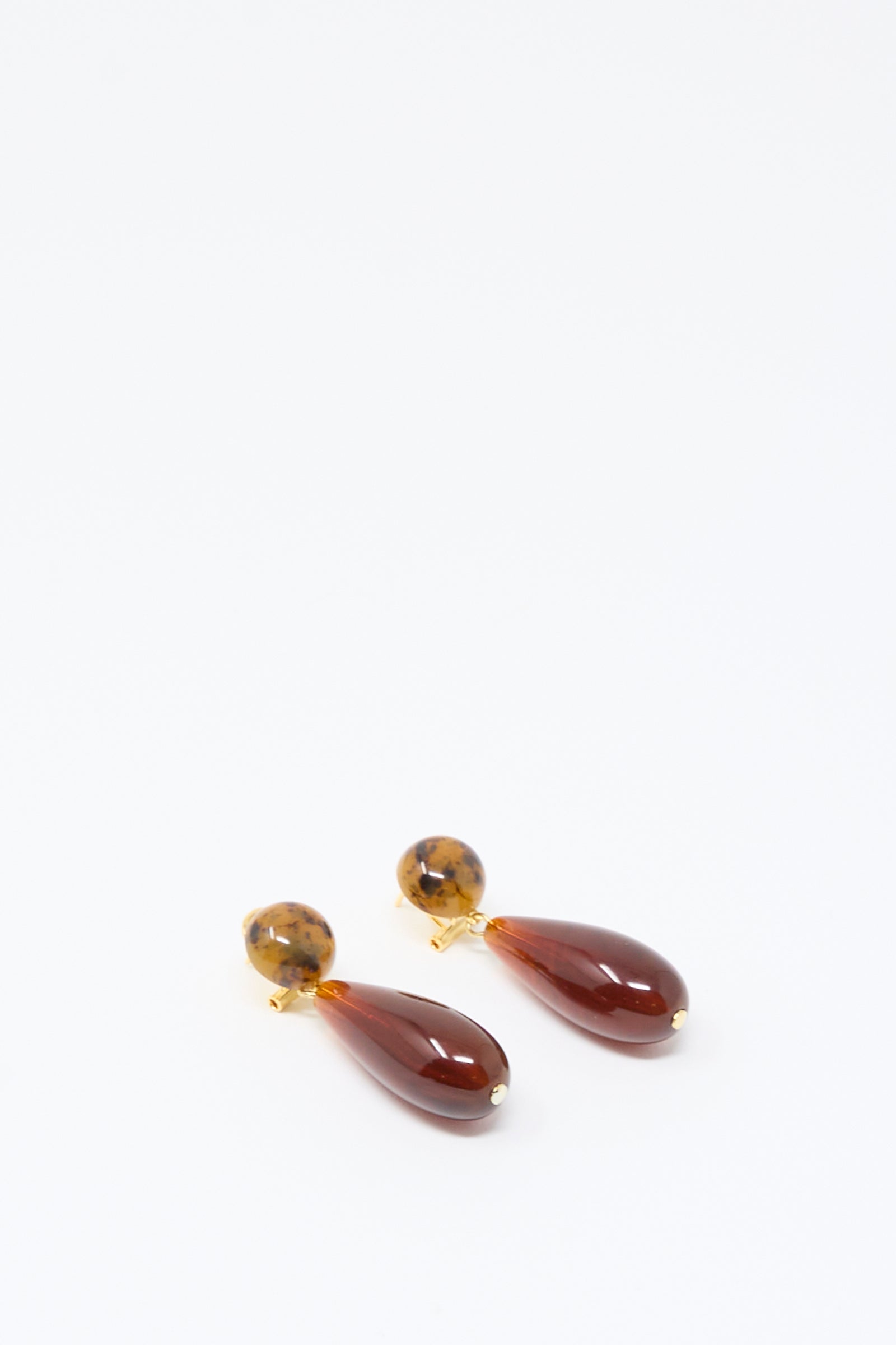 A pair of Pamploma Earrings in Picture Jasper Multi by Rachel Comey, featuring round tortoiseshell studs and brown, teardrop-shaped pendants reminiscent of Picture Jasper, beautifully crafted in Italy and displayed on a plain white background.