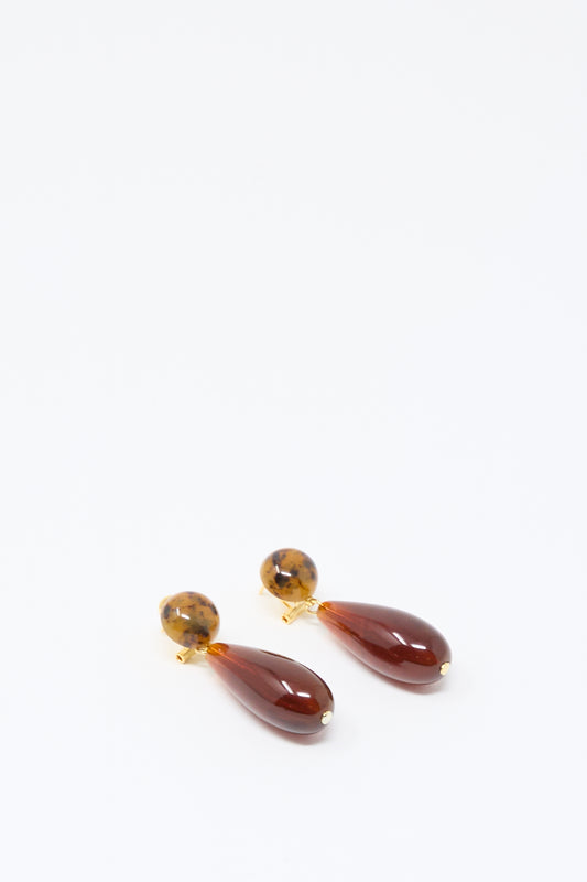 A pair of Pamploma Earrings in Picture Jasper Multi by Rachel Comey, featuring round tortoiseshell studs and brown, teardrop-shaped pendants reminiscent of Picture Jasper, beautifully crafted in Italy and displayed on a plain white background.
