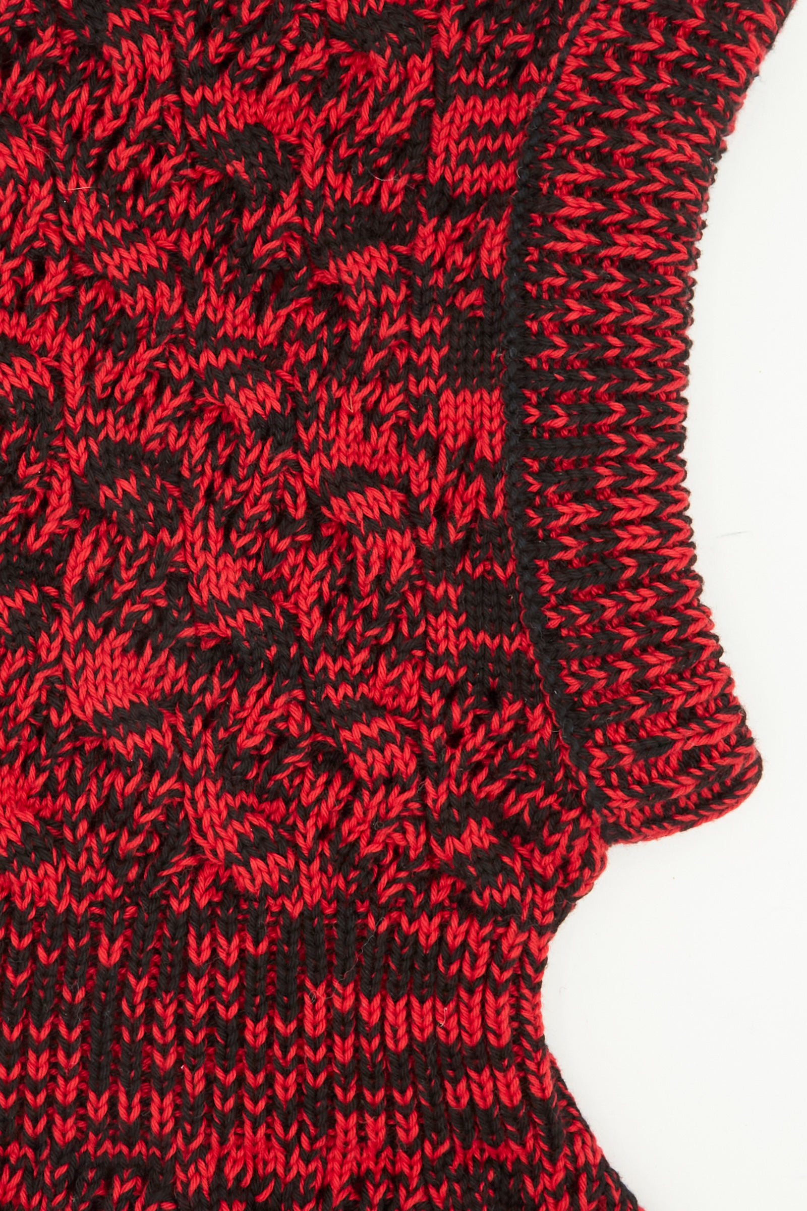 Close-up of the Zet Balaclava in Red Marle by Rachel Comey, featuring black and red marled knit, ribbed collar, and curved edge on a white background.