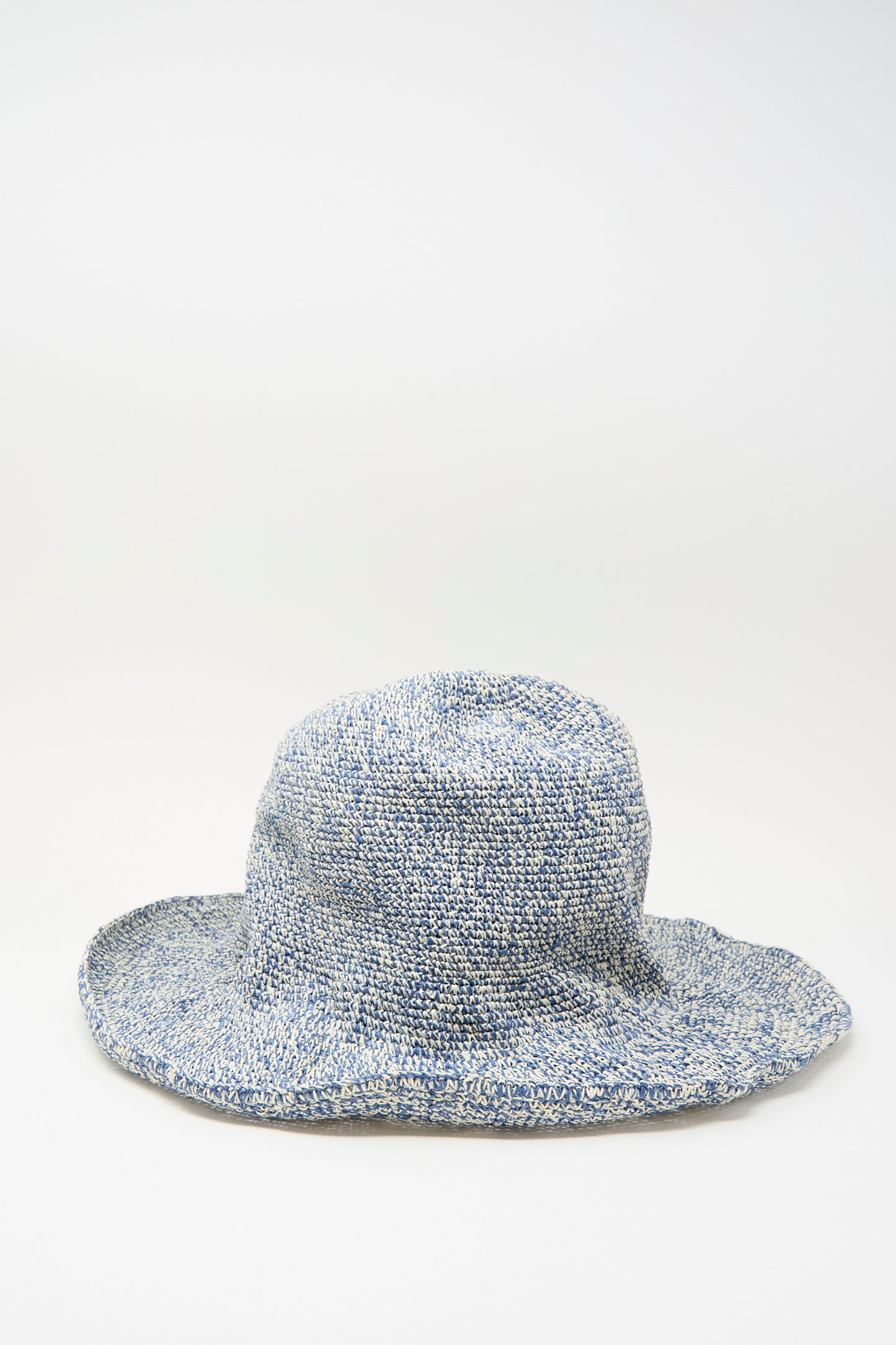 The Isle New Paper Hat in White, Blue by Reinhard Plank is a blue and white textured woven sun hat with a wide, floppy brim, inspired by classic bucket hat style, shown on a plain white background.