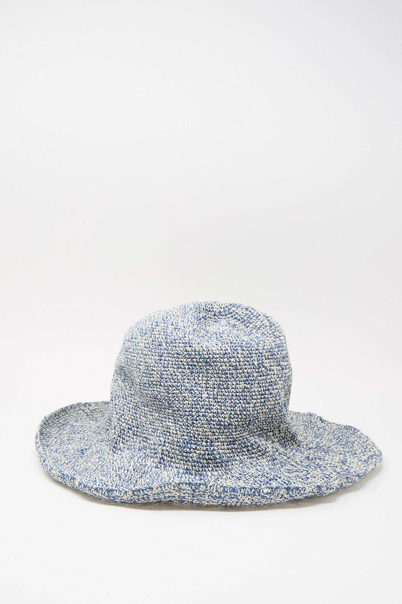 The Isle New Paper Hat in White, Blue by Reinhard Plank is a blue and white textured woven sun hat with a wide, floppy brim, inspired by classic bucket hat style, shown on a plain white background.