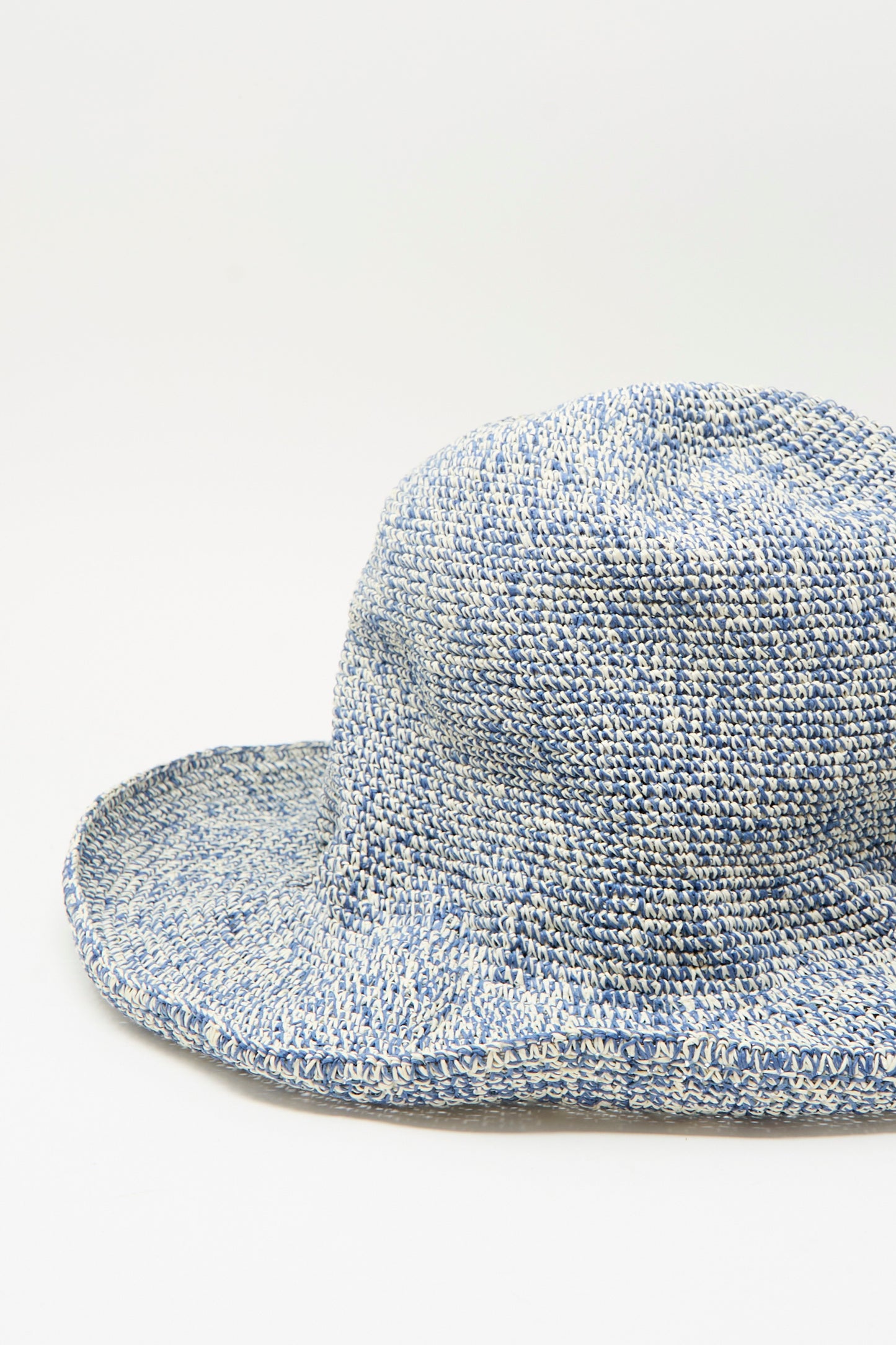 The Isle New Paper Hat in White and Blue by Reinhard Plank, made in Italy, features a wide brim and crocheted design, shown against a plain white background.