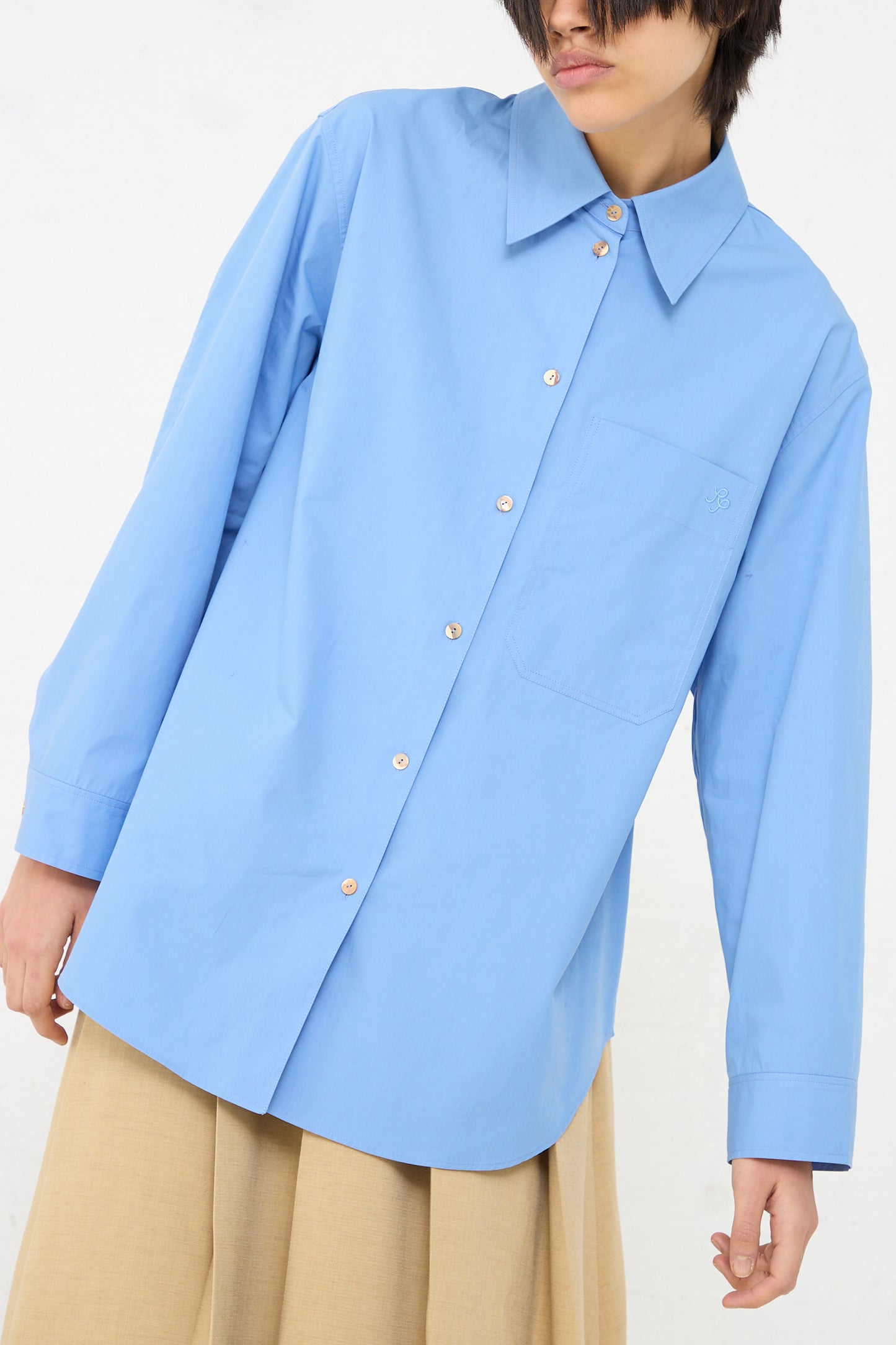 A woman wearing an oversized Caprice Shirt in Blue by Rejina Pyo.