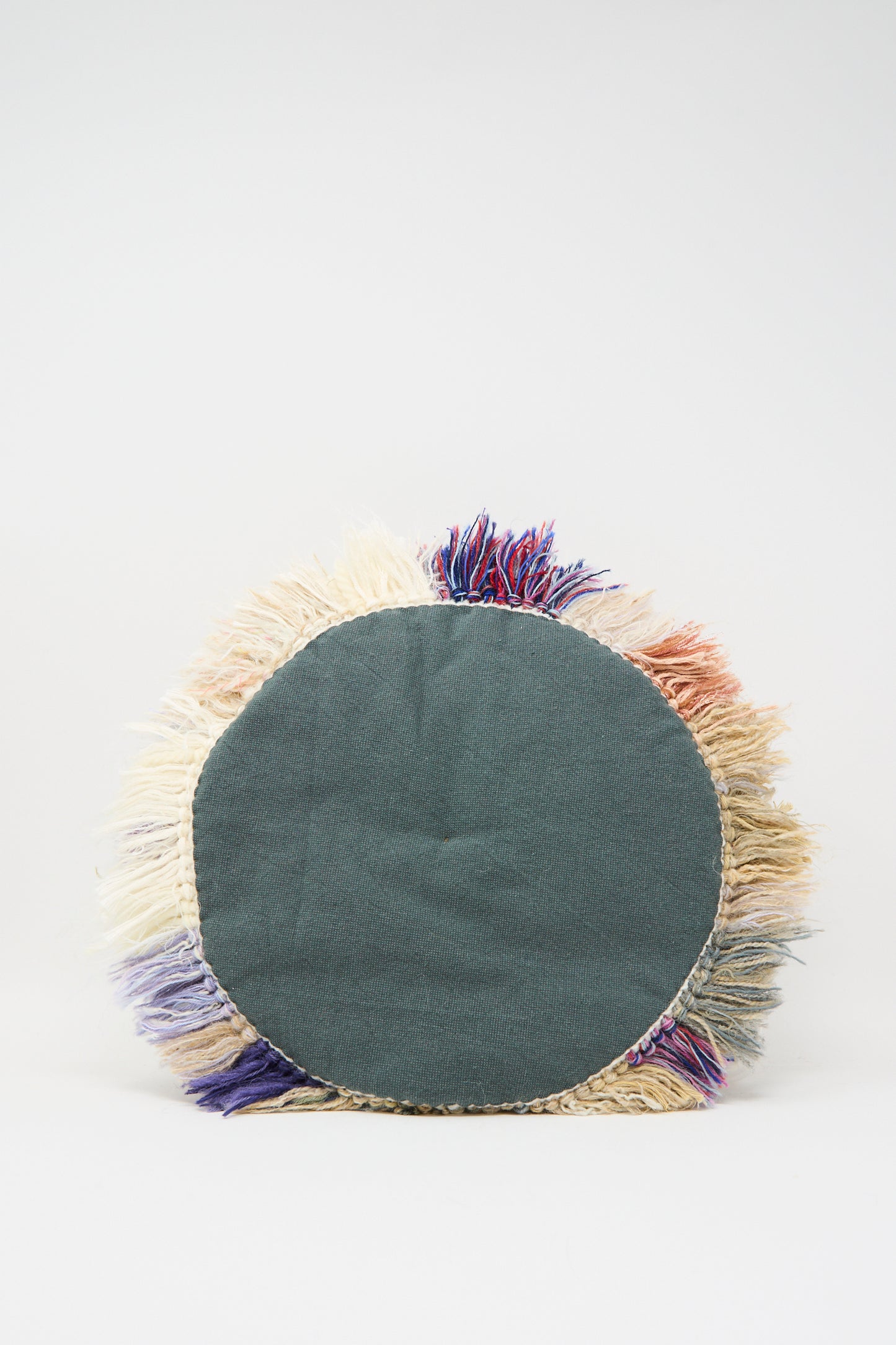 Renilde De Peuter's Handmade Cushion in Multi V features a solid dark green center with multicolored fringe, crafted from recycled yarns and shown against a plain white background.