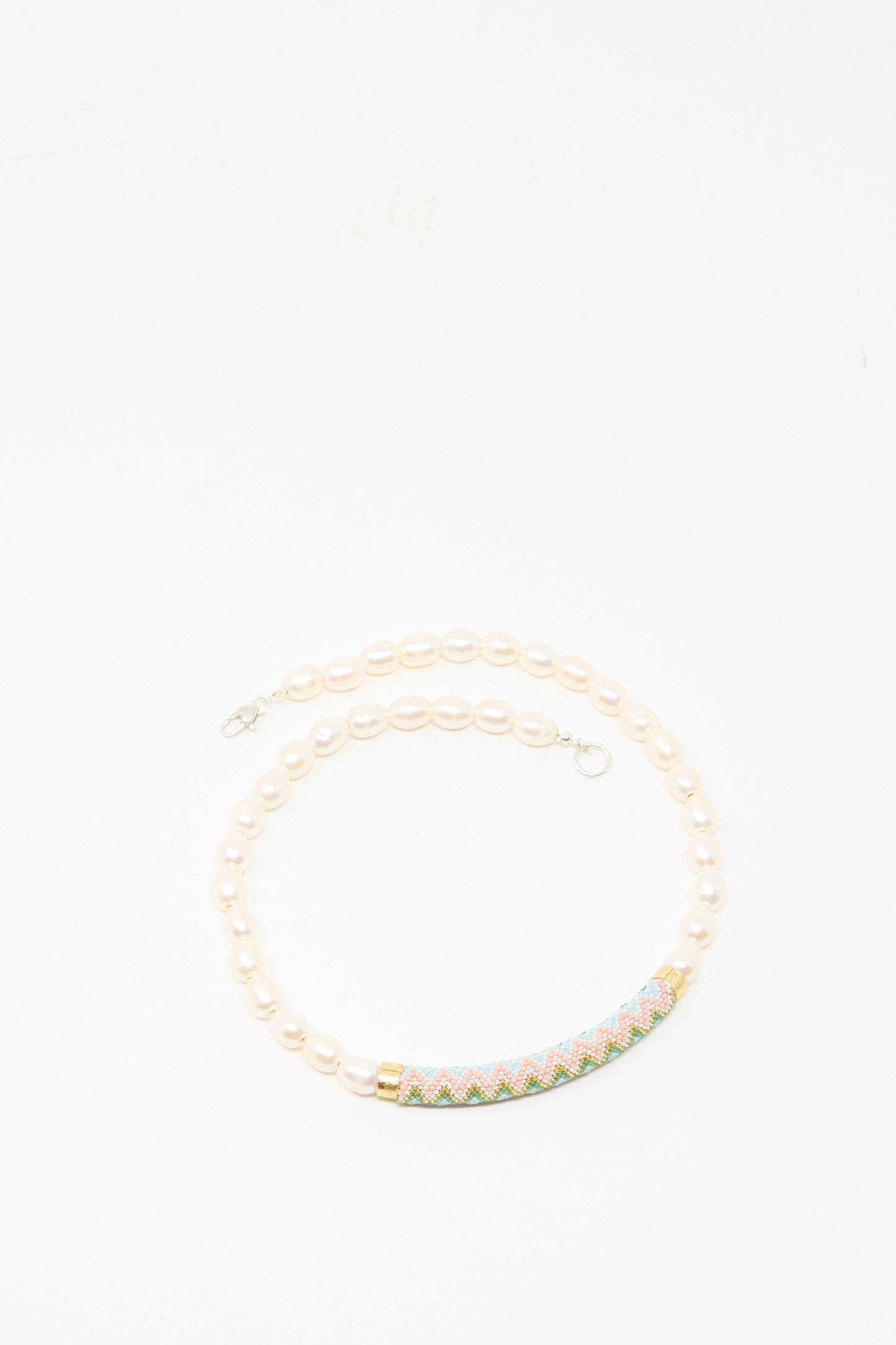 The Robin Mollicone Beaded Bar Necklace in Freshwater Pearl features white pearls and a multicolored chevron-patterned bar with sterling silver findings, shown on a white background.