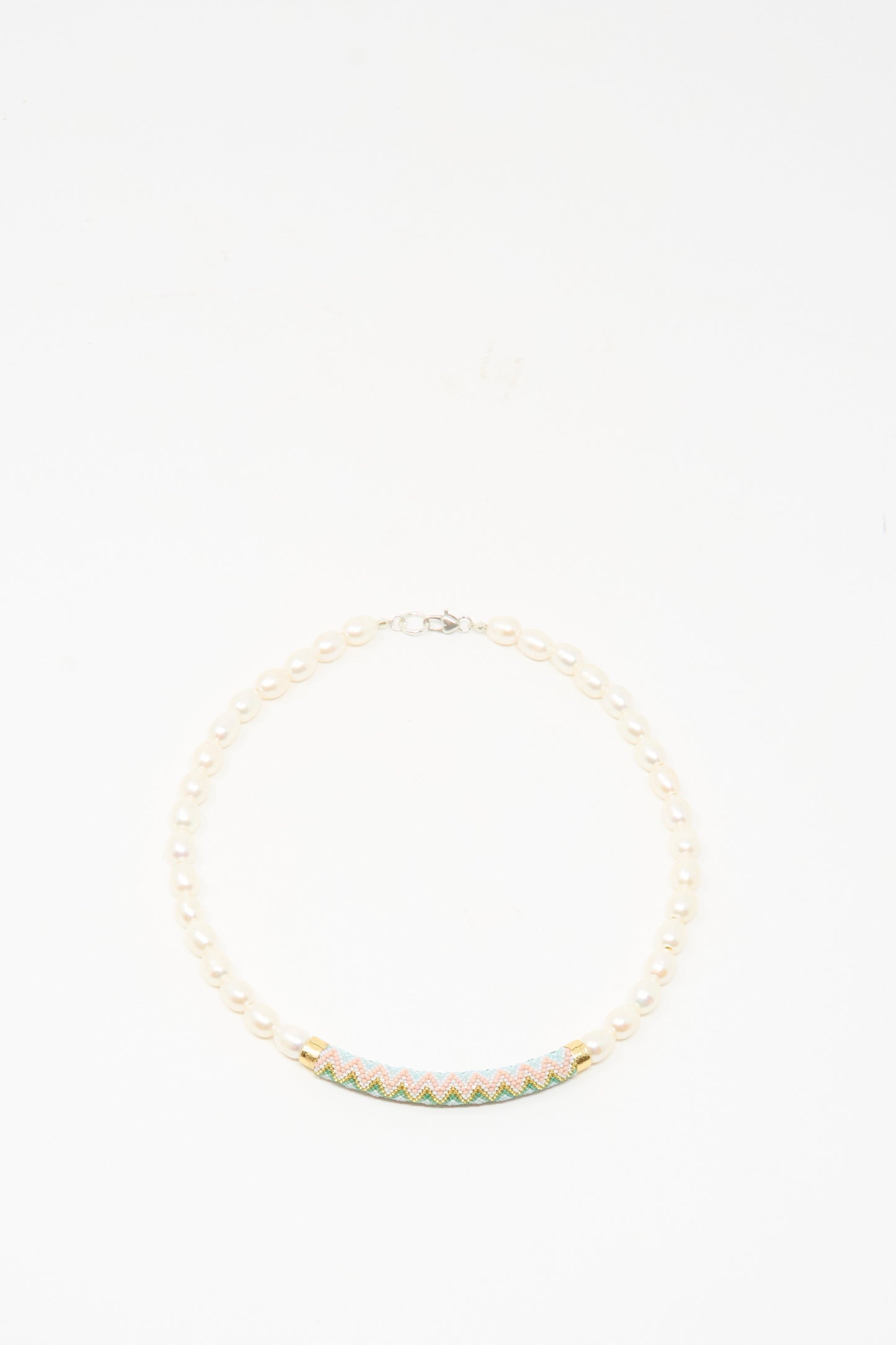 The Robin Mollicone Beaded Bar Necklace in Freshwater Pearl features a colorful, patterned curved bar centerpiece and sterling silver findings, shown on a white background.