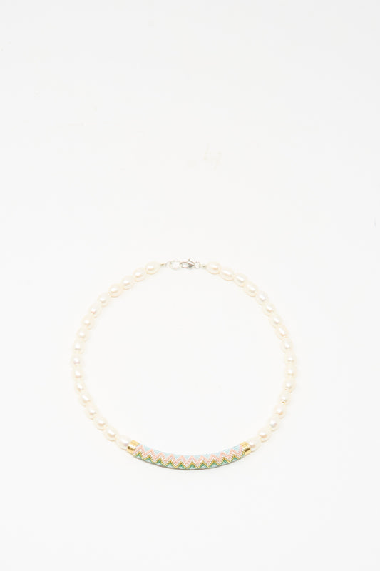 The Robin Mollicone Beaded Bar Necklace in Freshwater Pearl features a colorful, patterned curved bar centerpiece and sterling silver findings, shown on a white background.