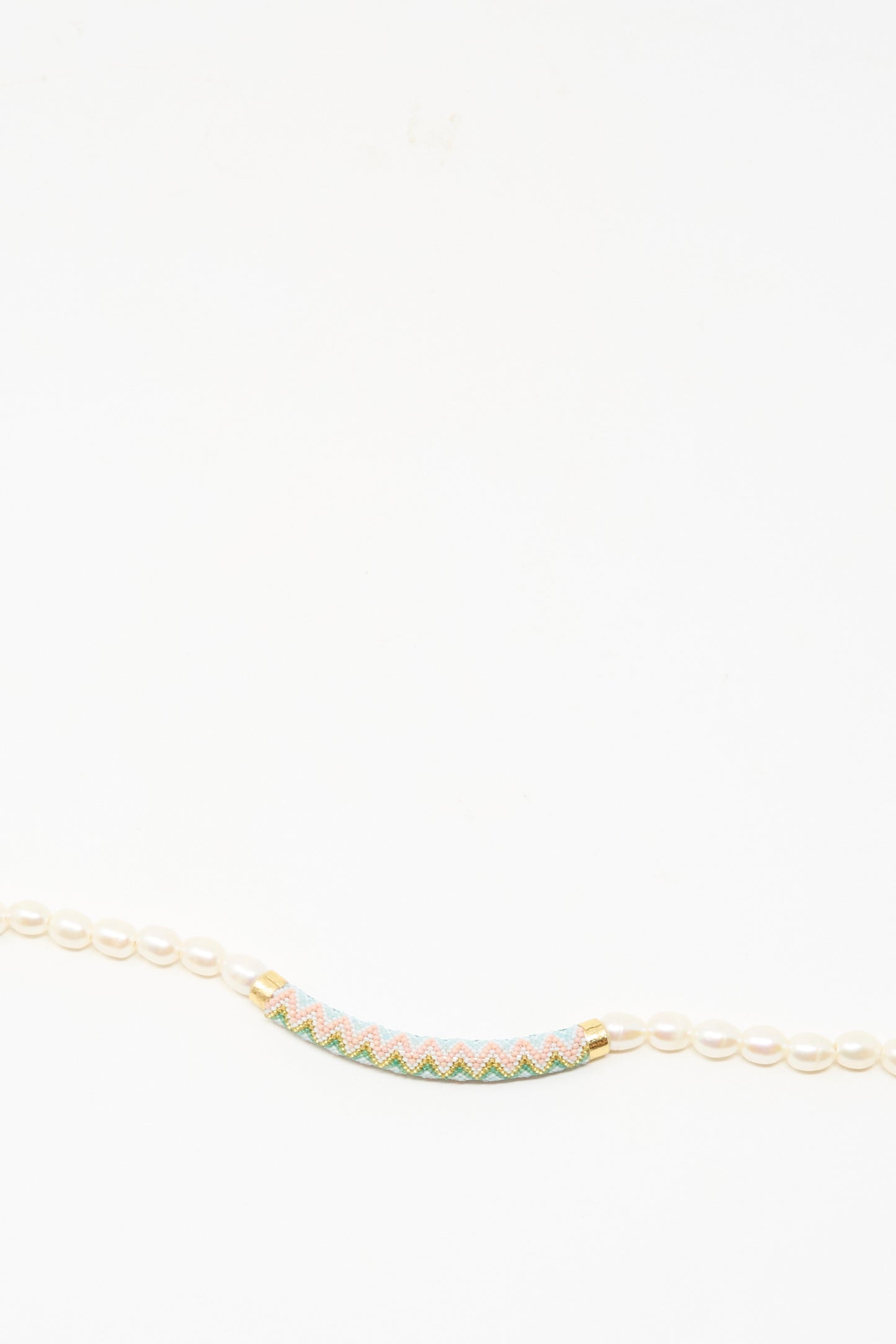 The Robin Mollicone Beaded Bar Necklace in Freshwater Pearl features small white pearls and a cylindrical multicolored beaded bar with gold accents and sterling silver details, shown against a white background.