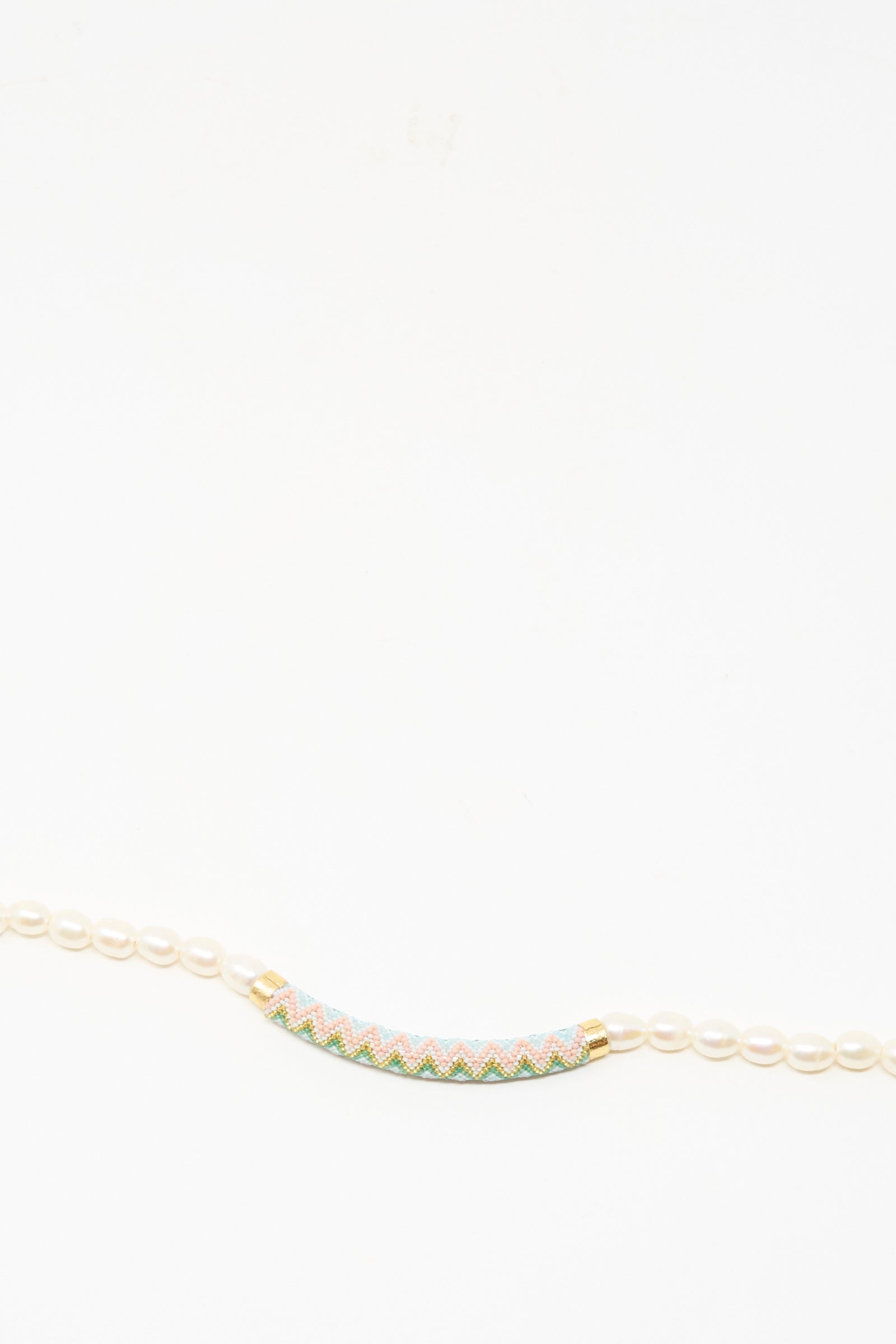The Robin Mollicone Beaded Bar Necklace in Freshwater Pearl features small white pearls and a cylindrical multicolored beaded bar with gold accents and sterling silver details, shown against a white background.